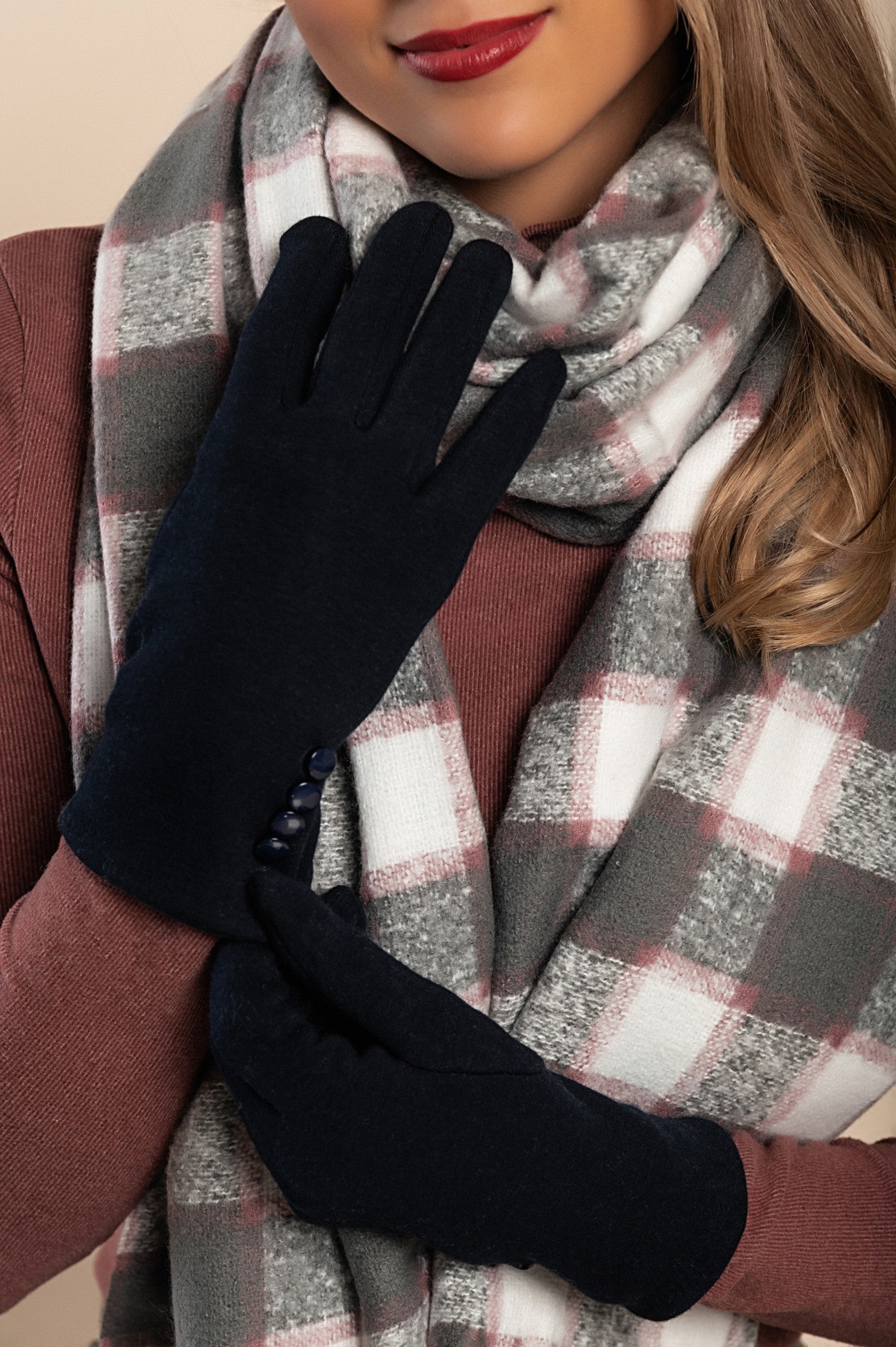 A pair of blue gloves featuring decorative buttons, made from soft and warm fabric, ideal for winter wear.