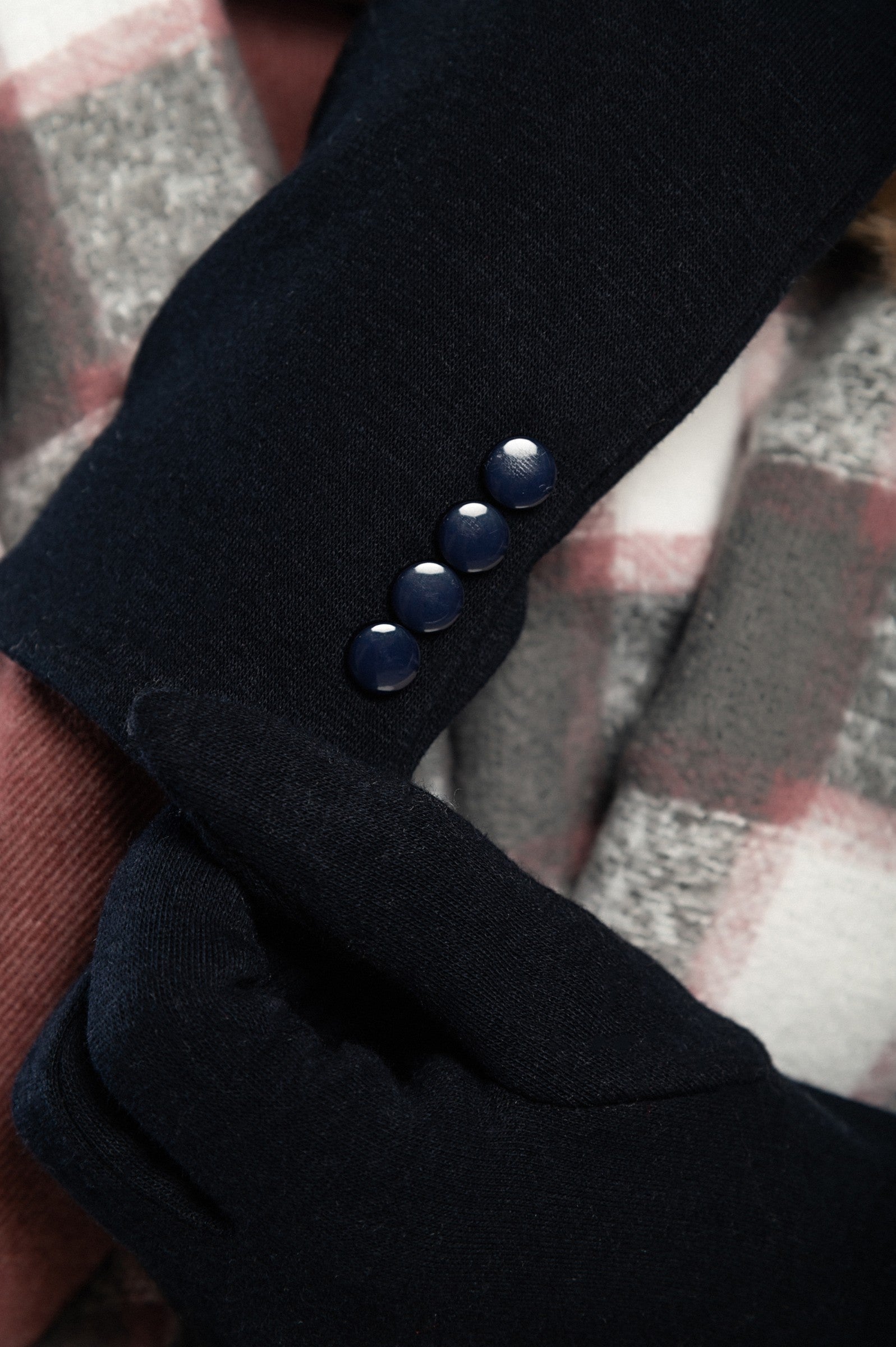 A pair of blue gloves featuring decorative buttons, made from soft and warm fabric, ideal for winter wear.