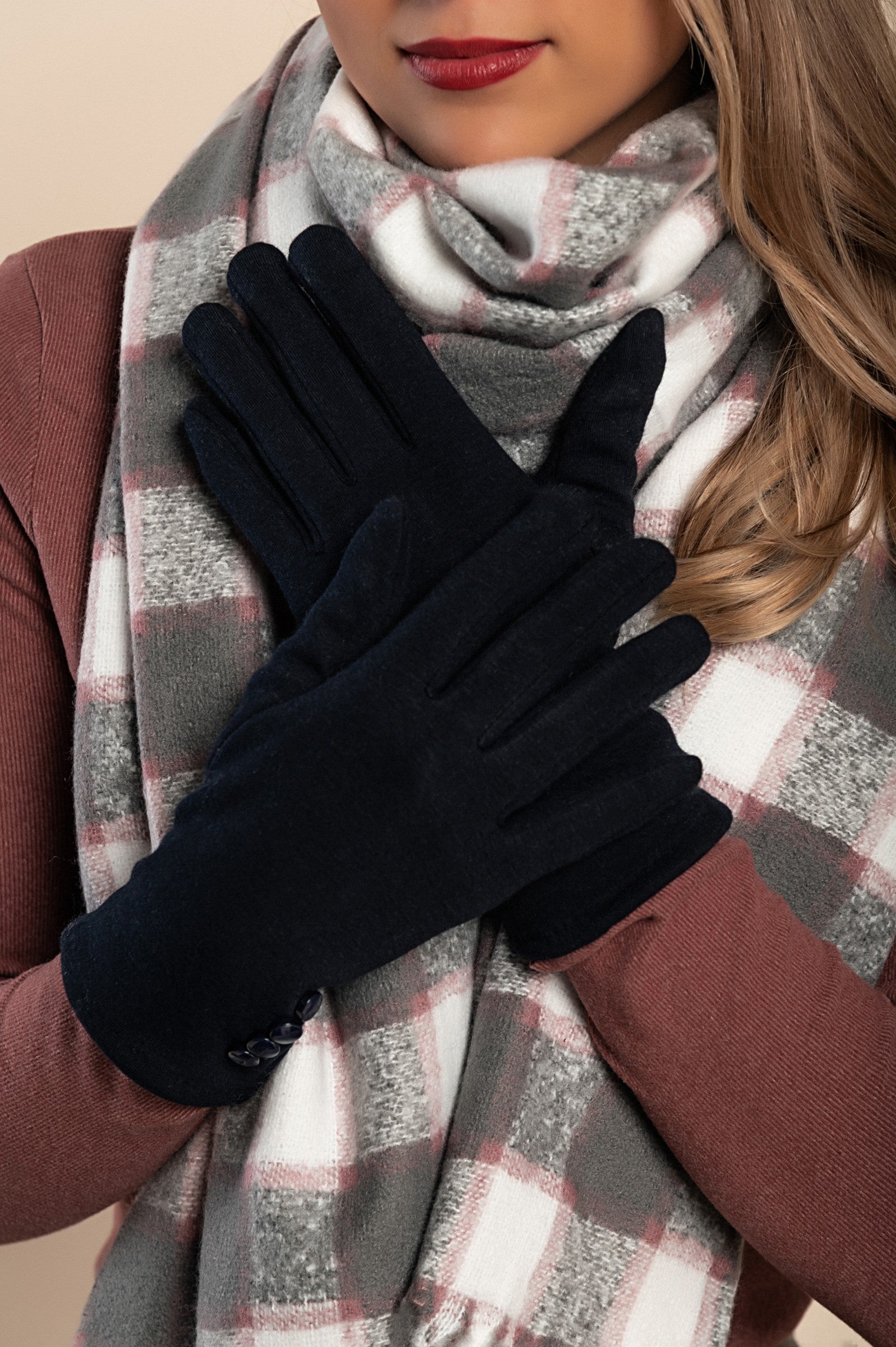 A pair of blue gloves featuring decorative buttons, made from soft and warm fabric, ideal for winter wear.