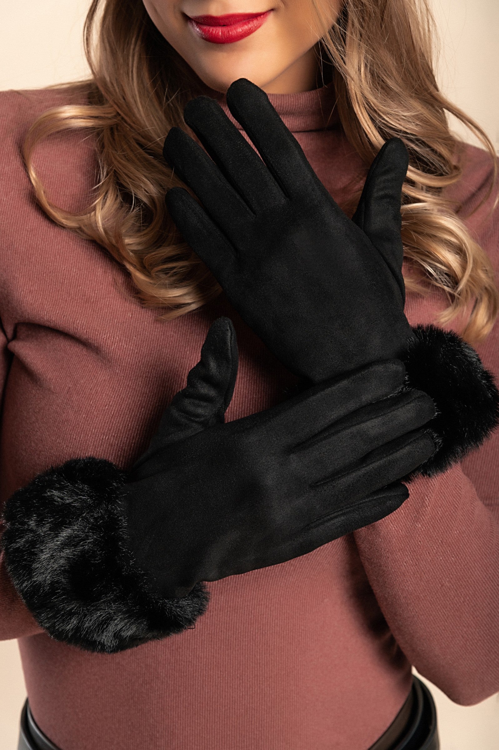 A pair of elegant black gloves with faux fur trim around the wrist, showcasing a soft and padded design for warmth and comfort.