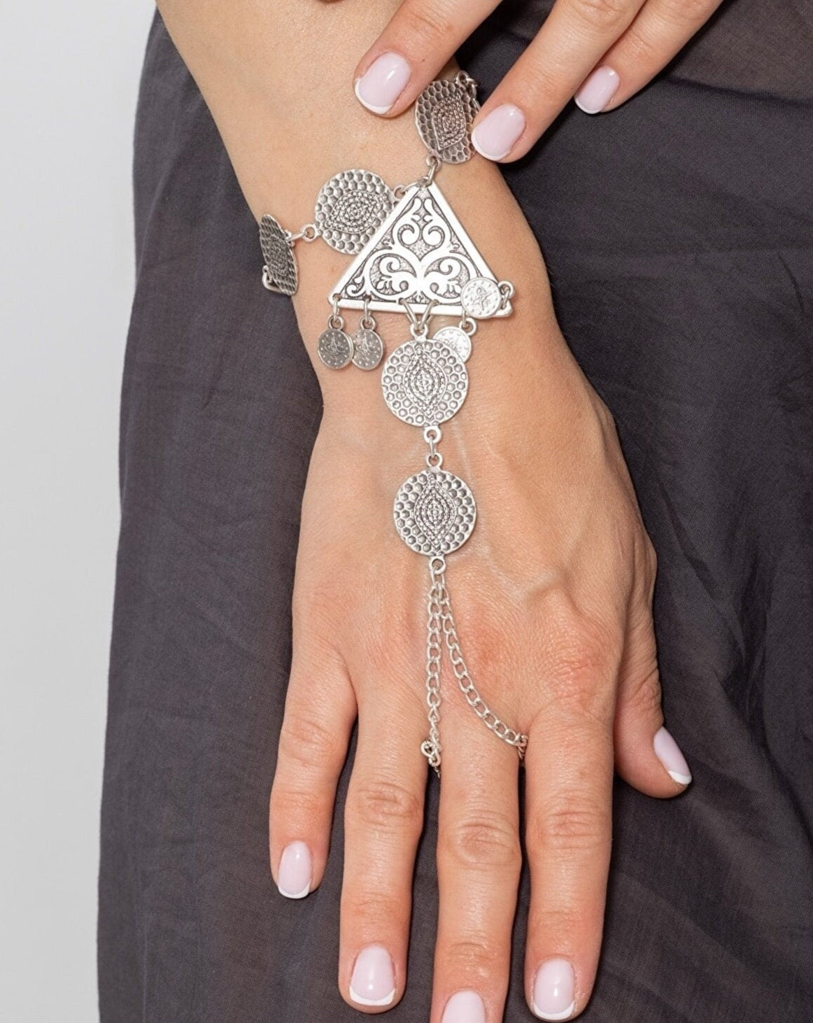 A beautifully crafted silver plated triangle bracelet, showcasing intricate metalwork and a luxurious design, perfect for any occasion.