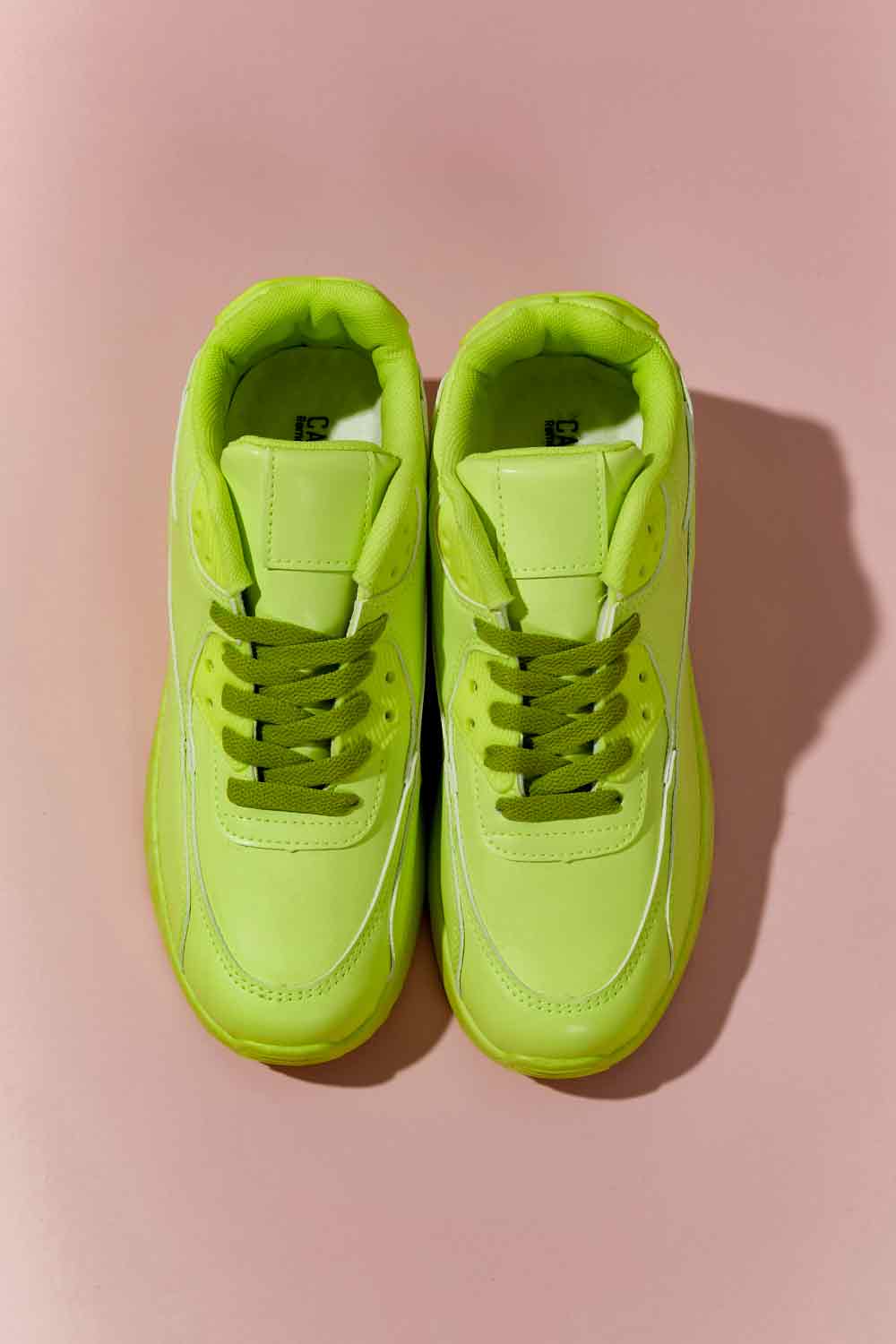 A pair of vibrant neon sneakers with a round toe and low heel, perfect for stylish outfits and active lifestyles.