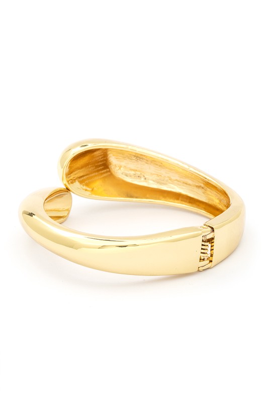 Gold Tone Organic Polished Hinged Bangle with a sleek design and spring hinged closure, showcasing its elegant gold finish.