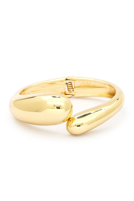 Gold Tone Organic Polished Hinged Bangle with a sleek design and spring hinged closure, showcasing its elegant gold finish.