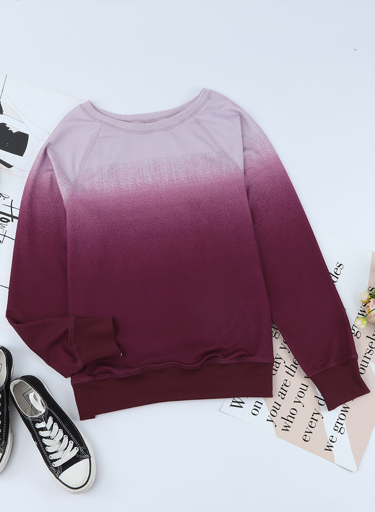 Gradient Raglan Sleeve Round Neck Sweatshirt displayed in a flat lay style, showcasing its unique gradient pattern and casual design.