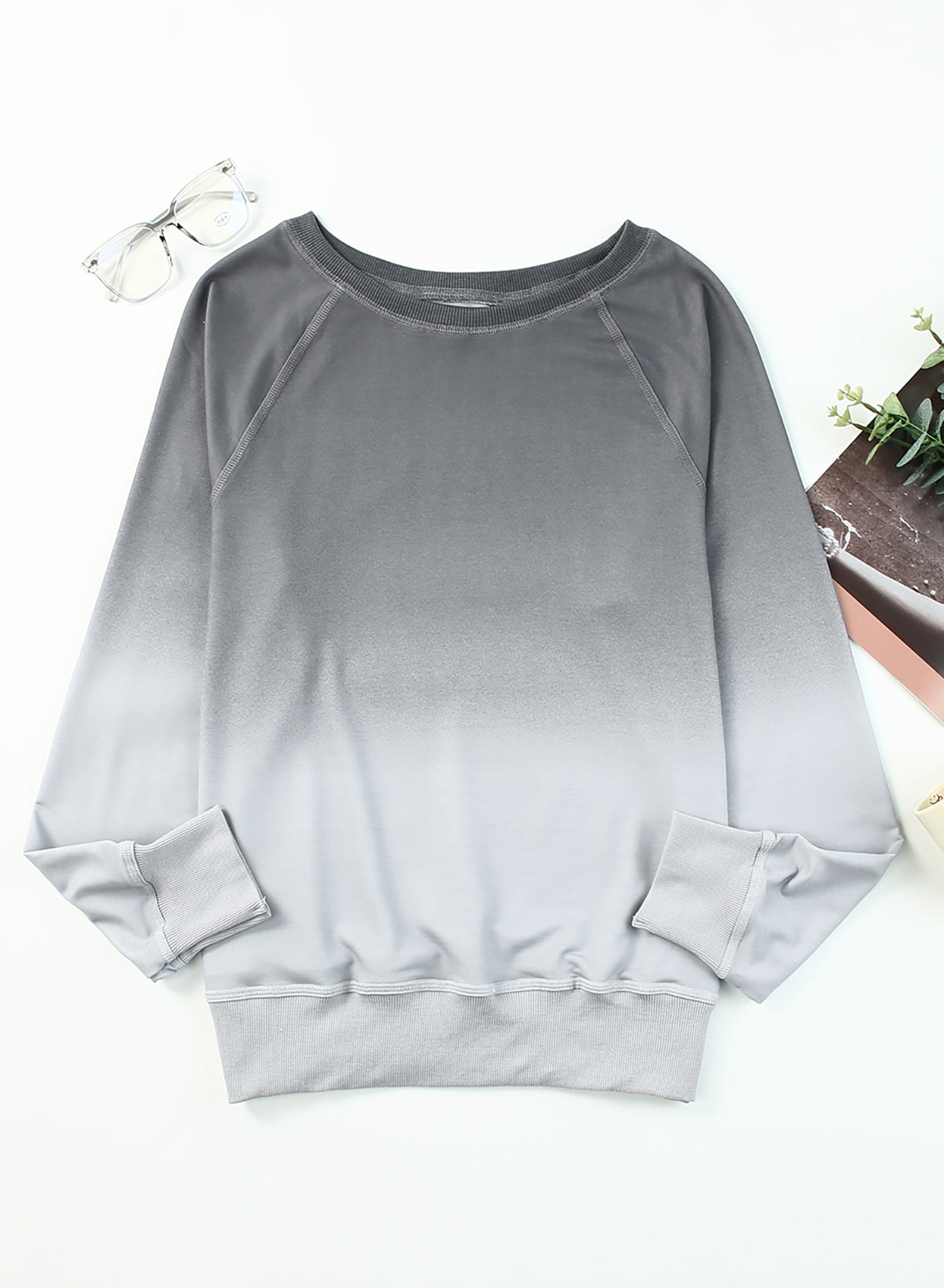 Gradient Raglan Sleeve Round Neck Sweatshirt displayed in a flat lay style, showcasing its unique gradient pattern and casual design.