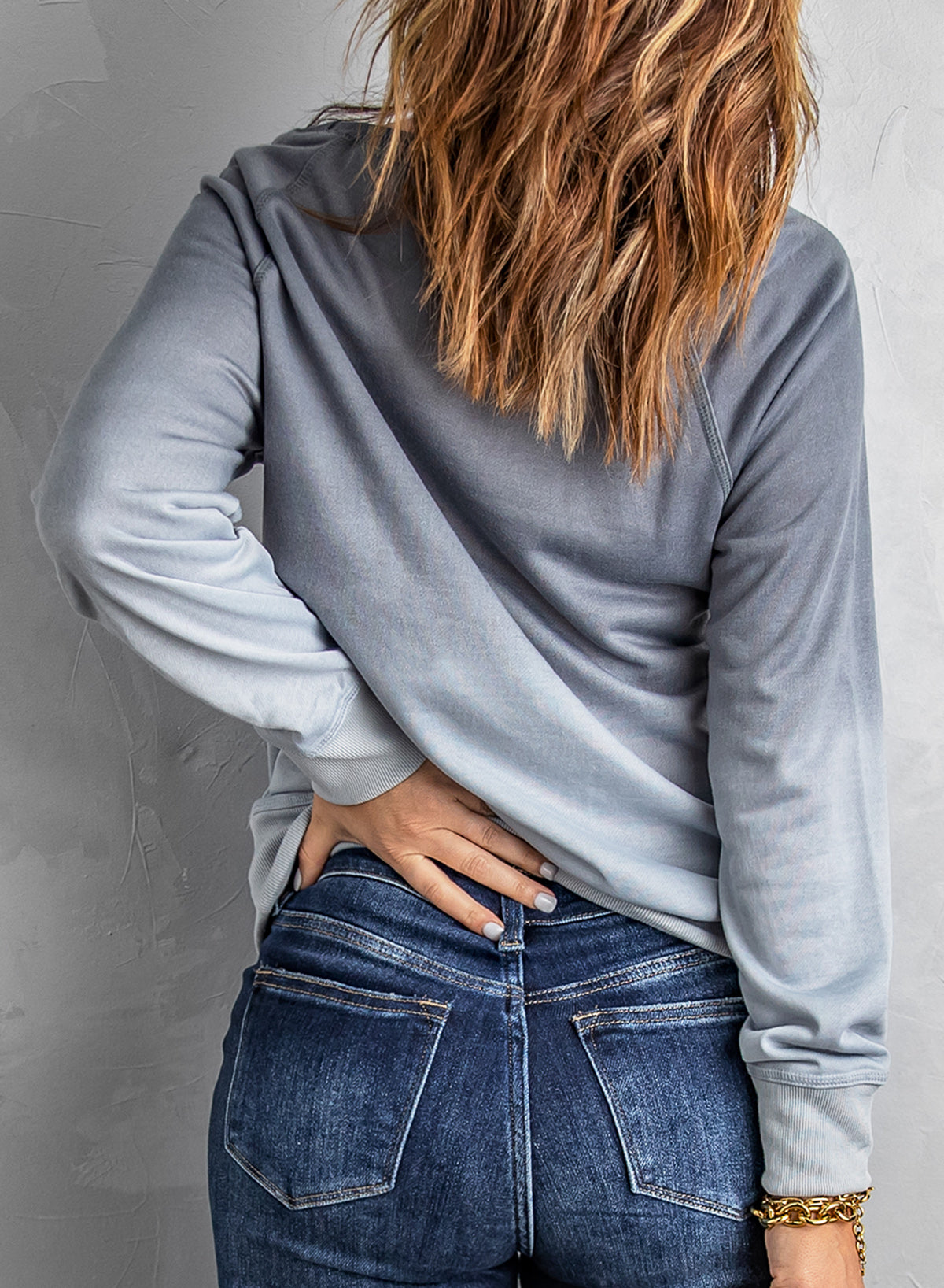 Gradient Raglan Sleeve Round Neck Sweatshirt displayed in a flat lay style, showcasing its unique gradient pattern and casual design.