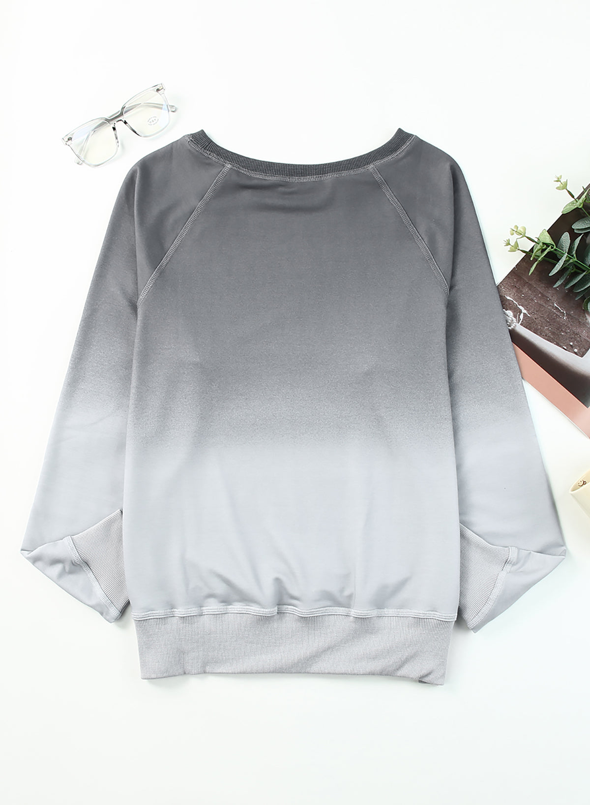 Gradient Raglan Sleeve Round Neck Sweatshirt displayed in a flat lay style, showcasing its unique gradient pattern and casual design.