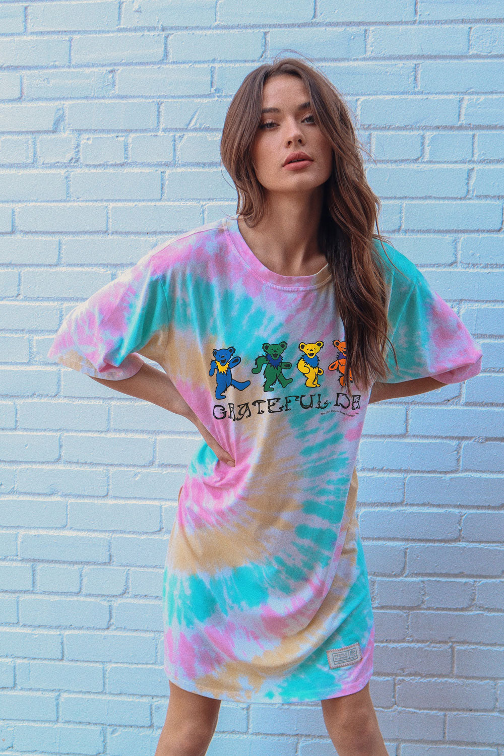 A colorful Grateful Dead Tee Dress Tie-Dye featuring a crewneck, side slit, and iconic bear graphic, made from organic cotton.