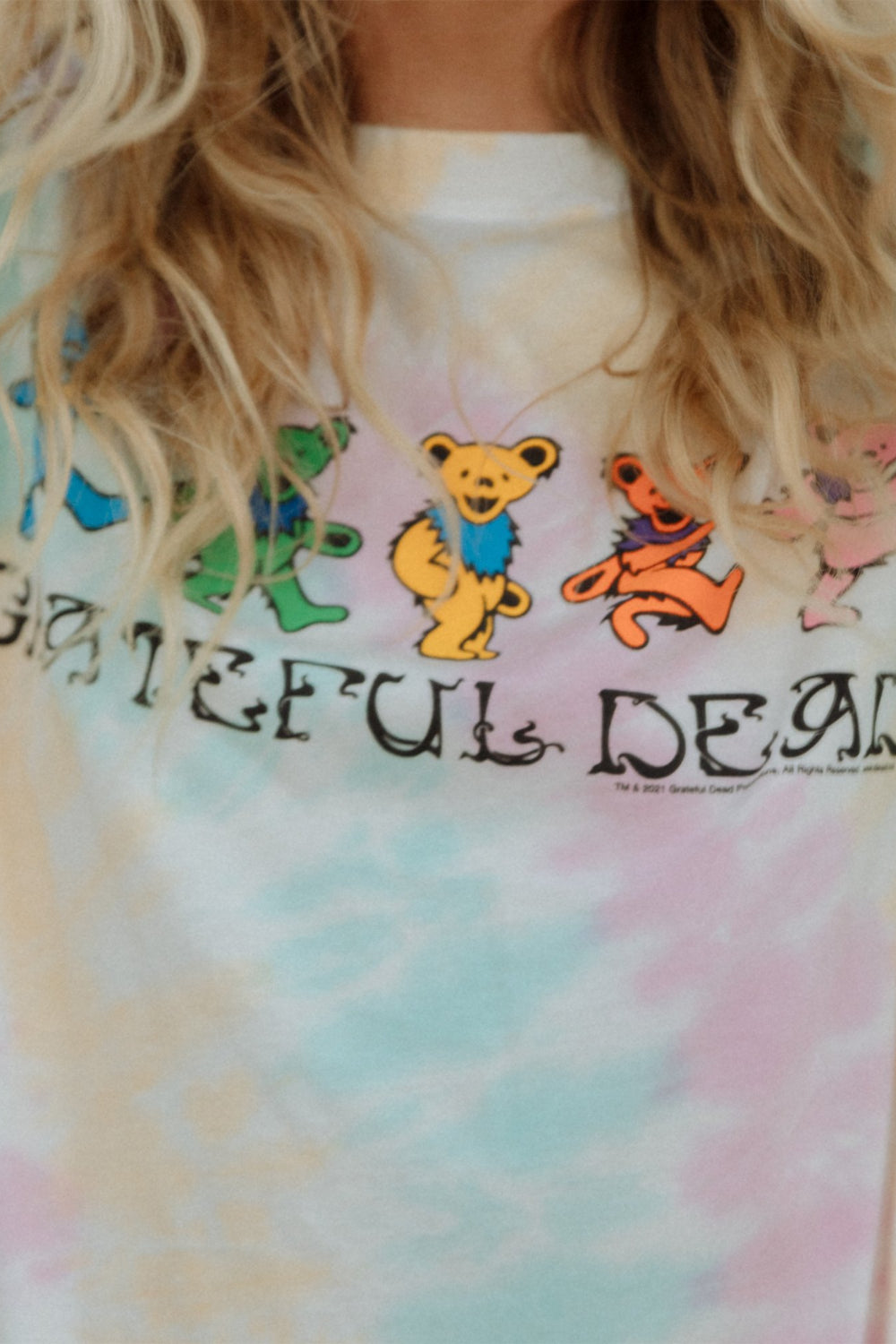 A colorful Grateful Dead Tee Dress Tie-Dye featuring a crewneck, side slit, and iconic bear graphic, made from organic cotton.