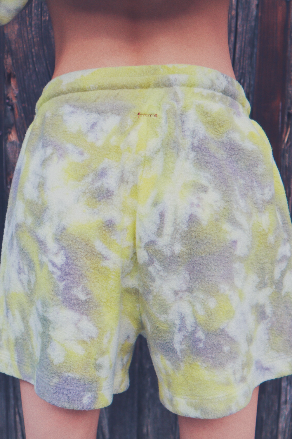 A pair of vibrant tie-dye shorts in Malibu and Miami colors, made from eco-friendly plush fleece fabric, featuring a drawstring waist and trouser pockets.