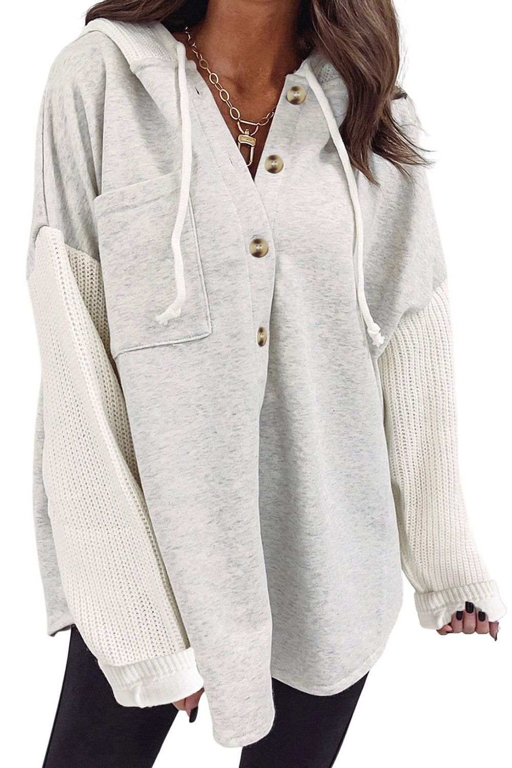 Gray button-up hooded jacket with contrast knitted sleeves, showcasing a stylish and cozy design.