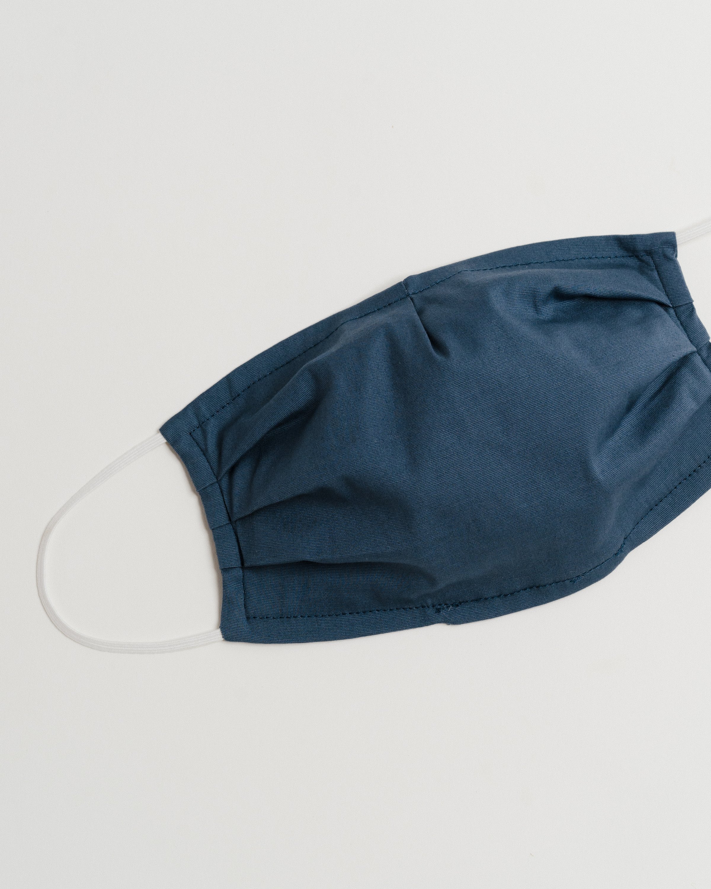 Gray Oxford Face Mask made from 100% cotton, featuring a pleated design for comfort and a pocket for filter insertion.