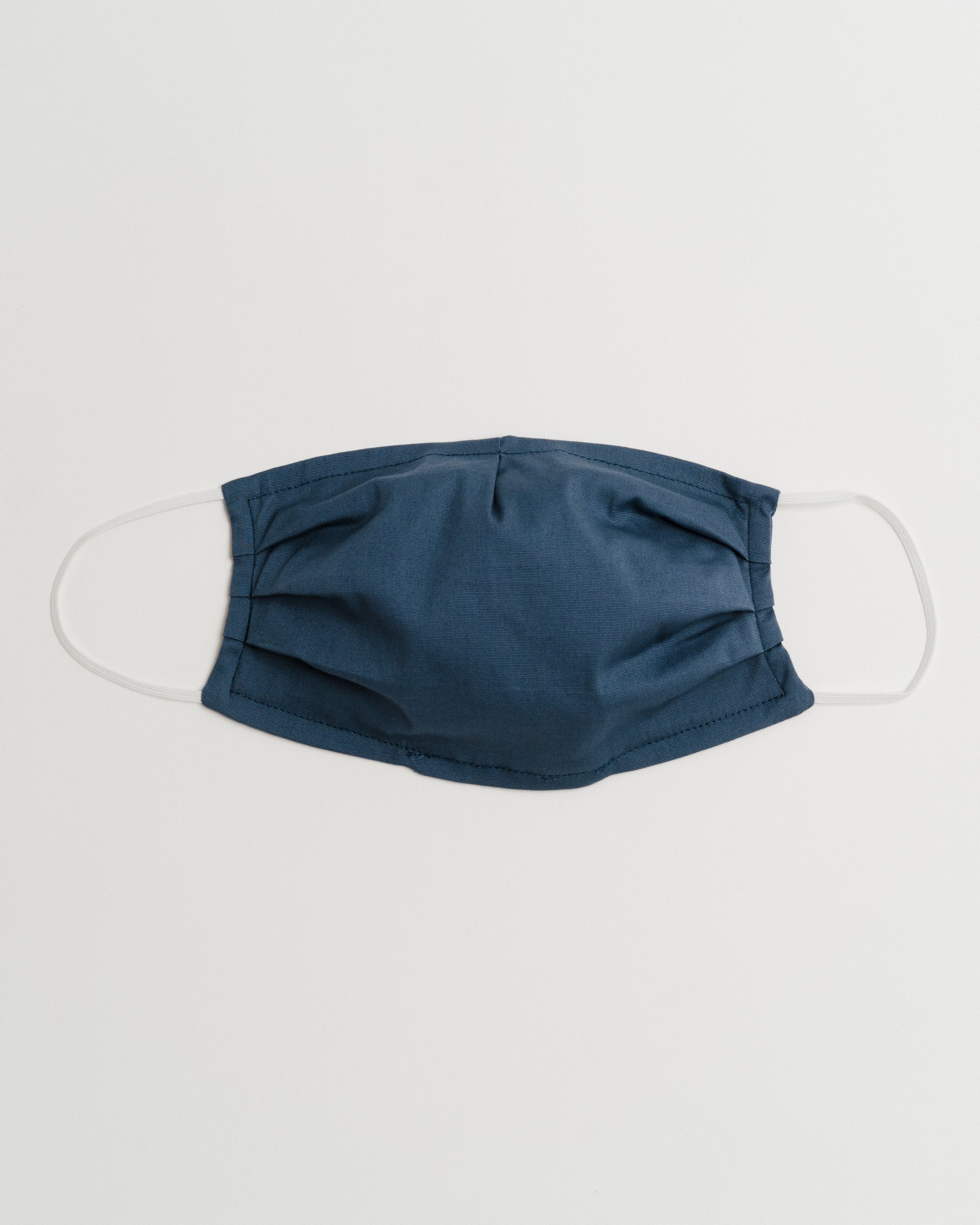 Gray Oxford Face Mask made from 100% cotton, featuring a pleated design for comfort and a pocket for filter insertion.