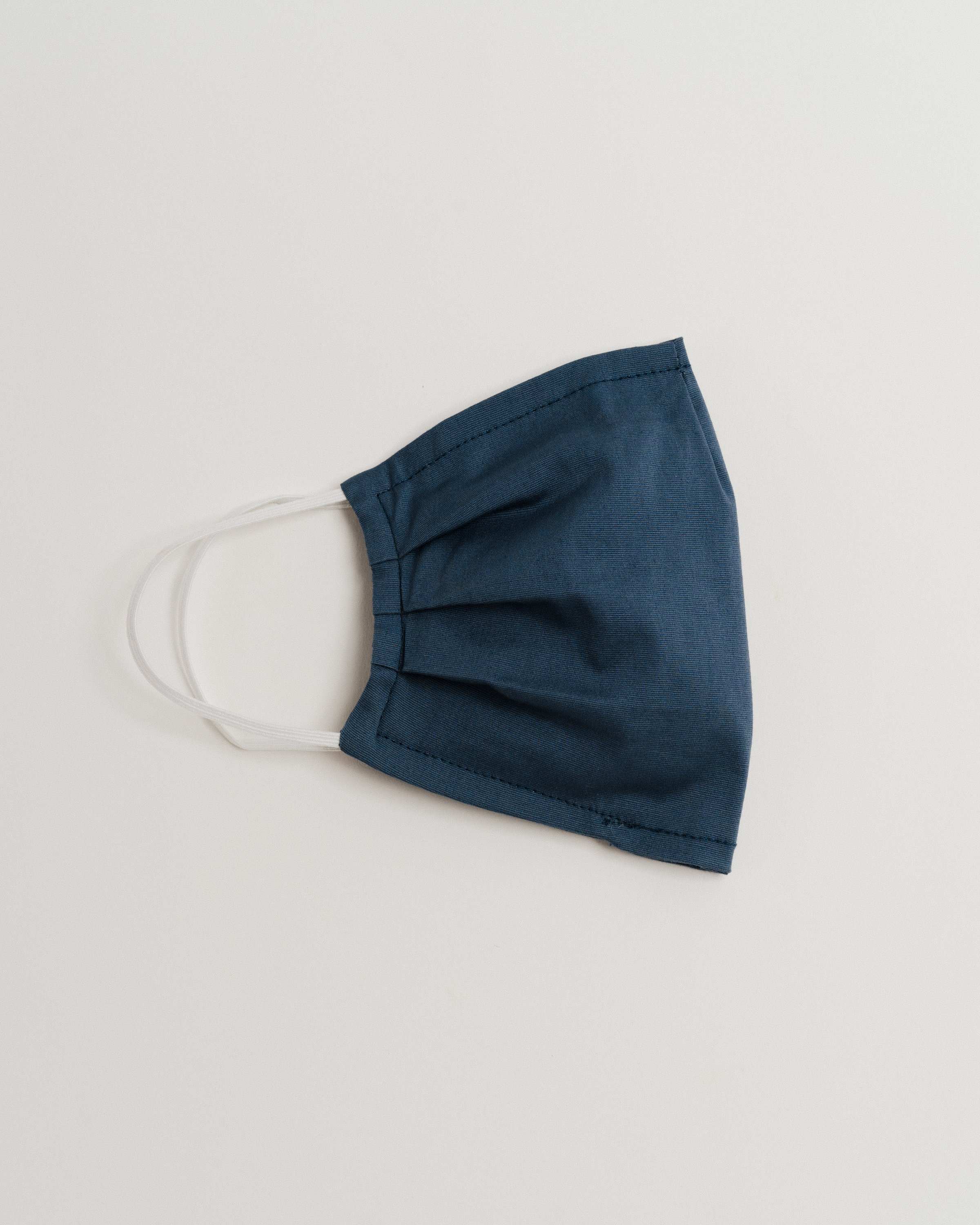 Gray Oxford Face Mask made from 100% cotton, featuring a pleated design for comfort and a pocket for filter insertion.