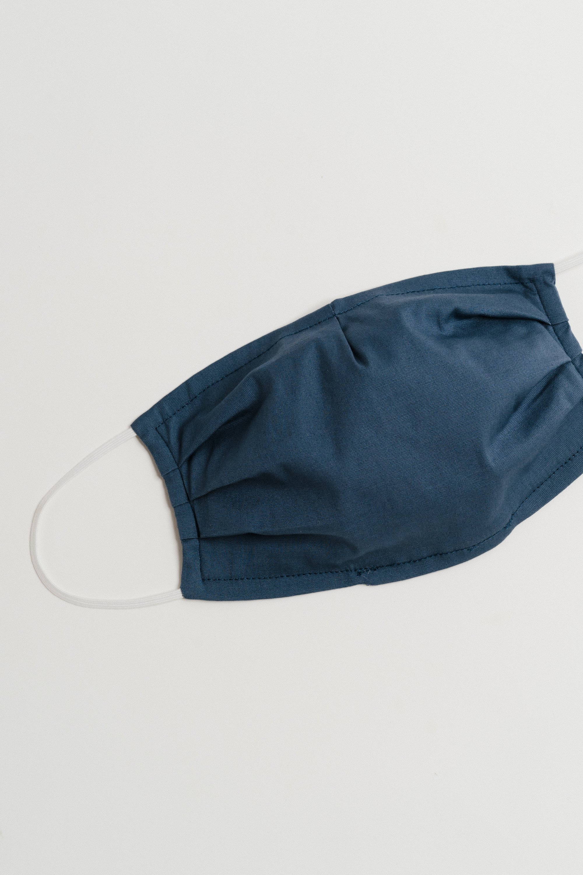 Gray Oxford Face Mask made from 100% cotton, featuring a pleated design for comfort and a pocket for filter insertion.