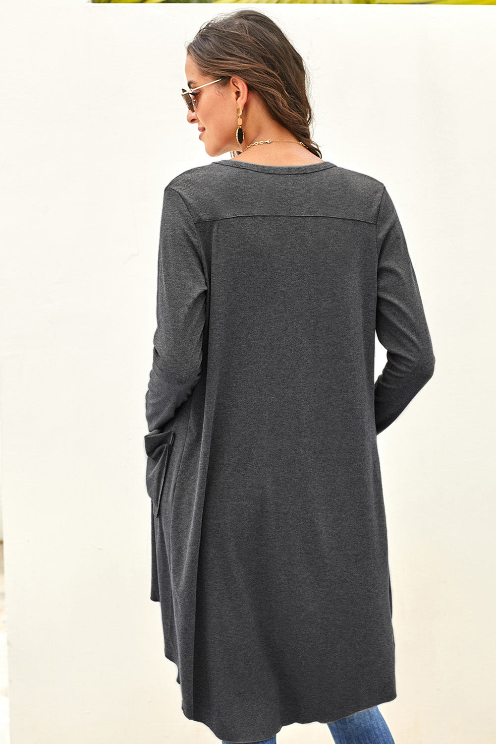 Gray long cardigan with button closure and side pockets, featuring a high low design, perfect for layering in any season.