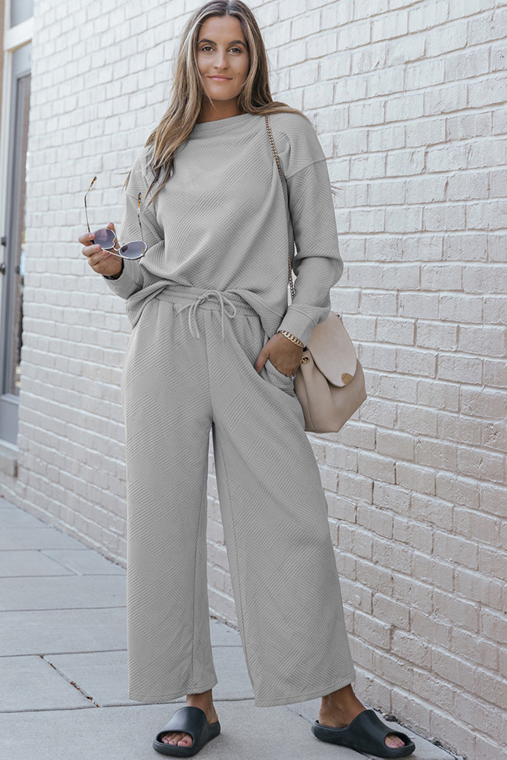 Gray ultra loose textured 2-piece slouchy outfit featuring a long-sleeved top and wide-leg pants with drawstrings, perfect for casual wear.