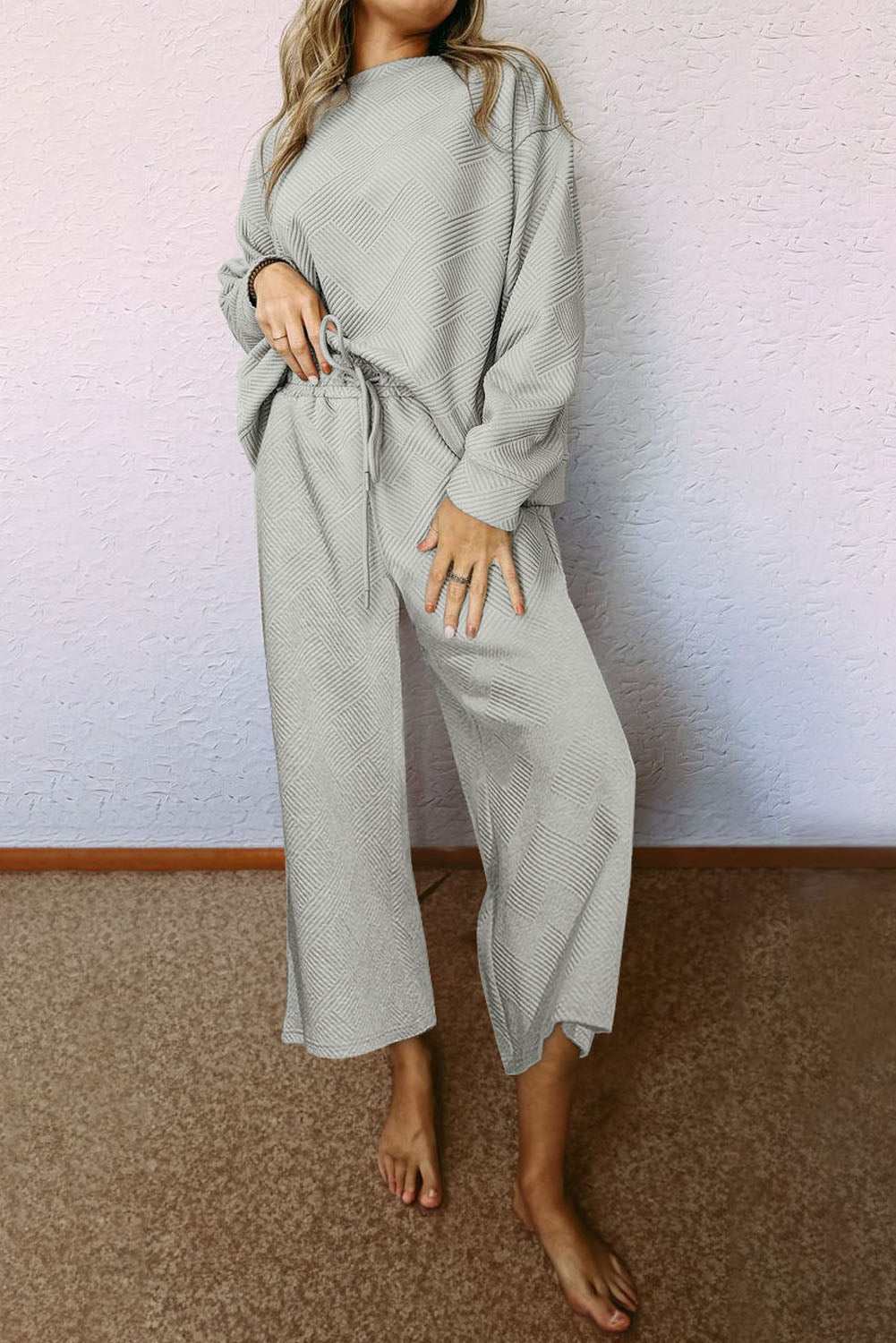 Gray ultra loose textured 2-piece slouchy outfit featuring a long-sleeved top and wide-leg pants with drawstrings, perfect for casual wear.