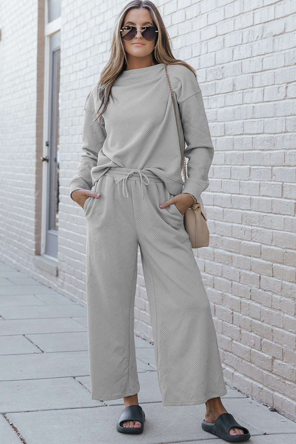 Gray ultra loose textured 2-piece slouchy outfit featuring a long-sleeved top and wide-leg pants with drawstrings, perfect for casual wear.