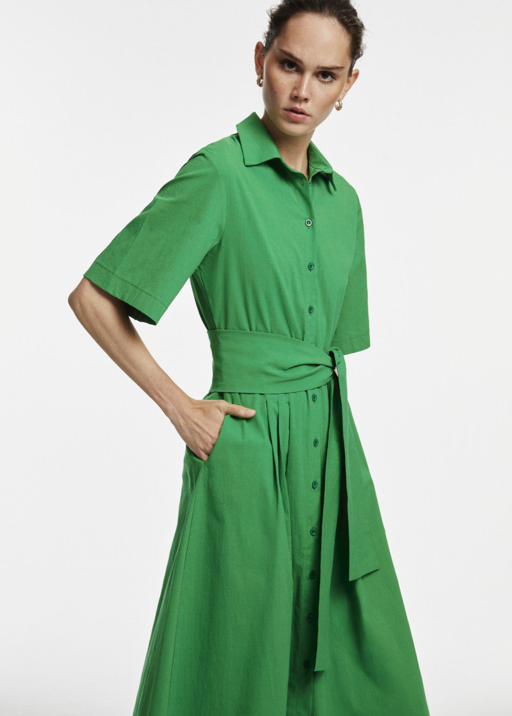 A stylish green midi shirt dress featuring a button-down design, perfect for various occasions.