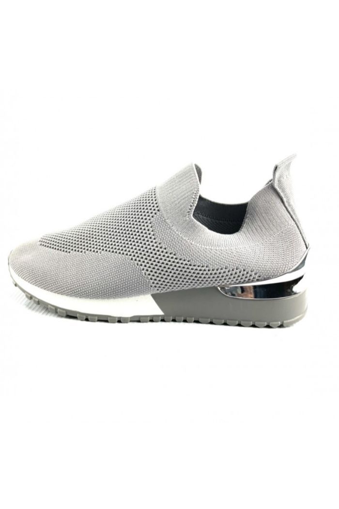 A pair of women's grey knitted sock trainers featuring a silver heel detail and a chunky black and white sole, perfect for summer wear.