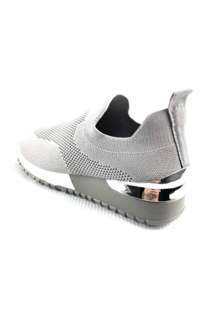 A pair of women's grey knitted sock trainers featuring a silver heel detail and a chunky black and white sole, perfect for summer wear.