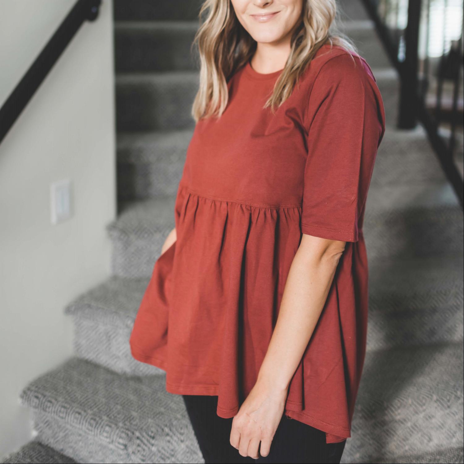 Half Sleeve Empire Waist Shirring Top in dusty teal with elegant ruffles and peplum design, showcasing its flattering silhouette.