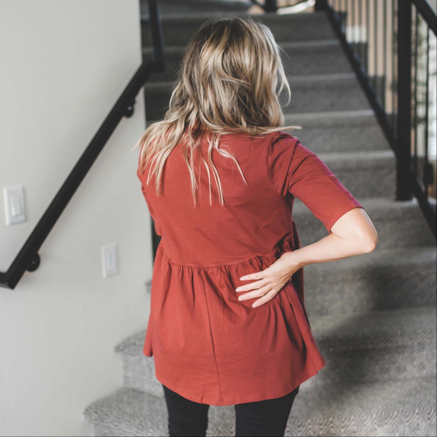 Half Sleeve Empire Waist Shirring Top in dusty teal with elegant ruffles and peplum design, showcasing its flattering silhouette.