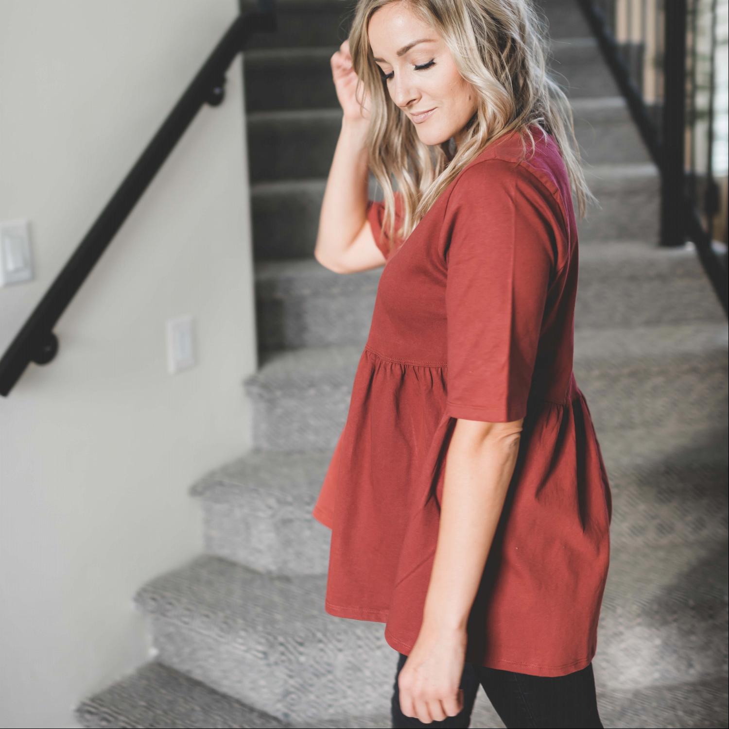 Half Sleeve Empire Waist Shirring Top in dusty teal with elegant ruffles and peplum design, showcasing its flattering silhouette.