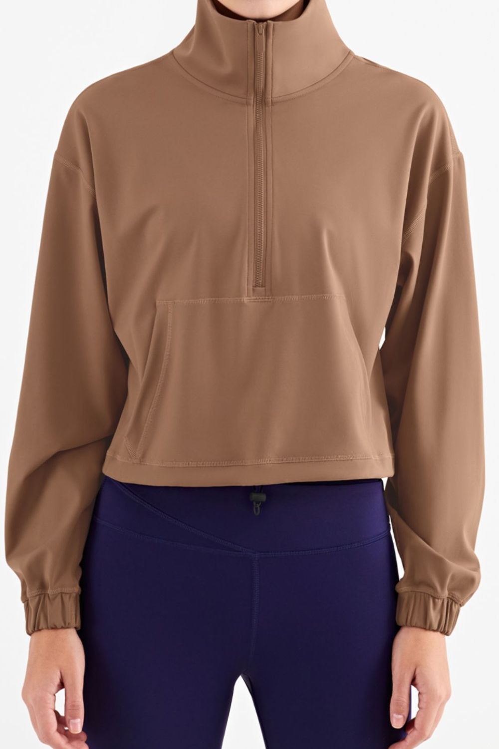 Half-Zip Dropped Shoulder Sports Top in a studio setting, showcasing its high neck and long sleeves, made from stretchy nylon and spandex.