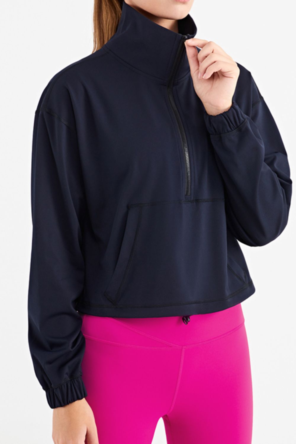 Half-Zip Dropped Shoulder Sports Top in a studio setting, showcasing its high neck and long sleeves, made from stretchy nylon and spandex.