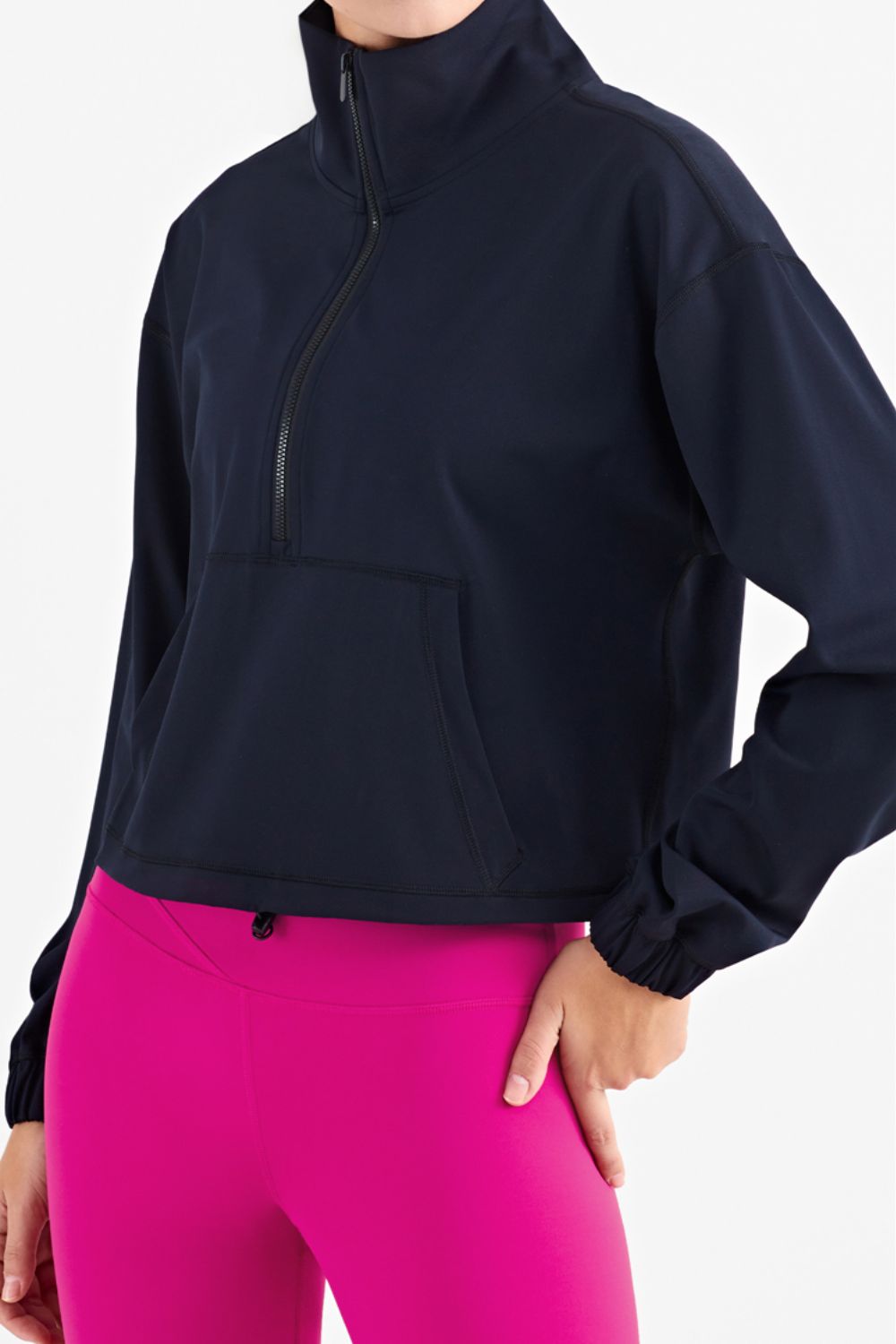 Half-Zip Dropped Shoulder Sports Top in a studio setting, showcasing its high neck and long sleeves, made from stretchy nylon and spandex.