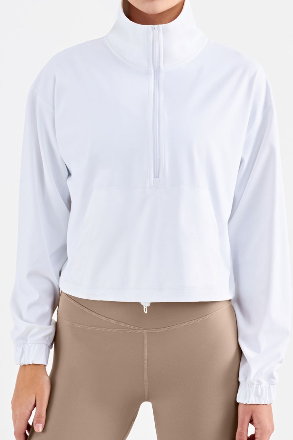 Half-Zip Dropped Shoulder Sports Top in a studio setting, showcasing its high neck and long sleeves, made from stretchy nylon and spandex.