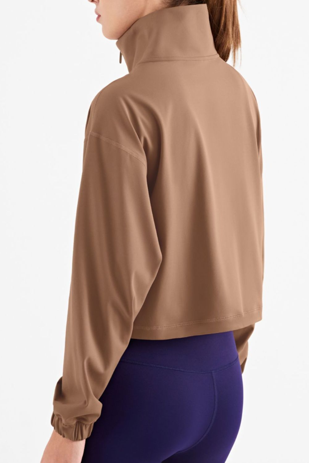 Half-Zip Dropped Shoulder Sports Top in a studio setting, showcasing its high neck and long sleeves, made from stretchy nylon and spandex.