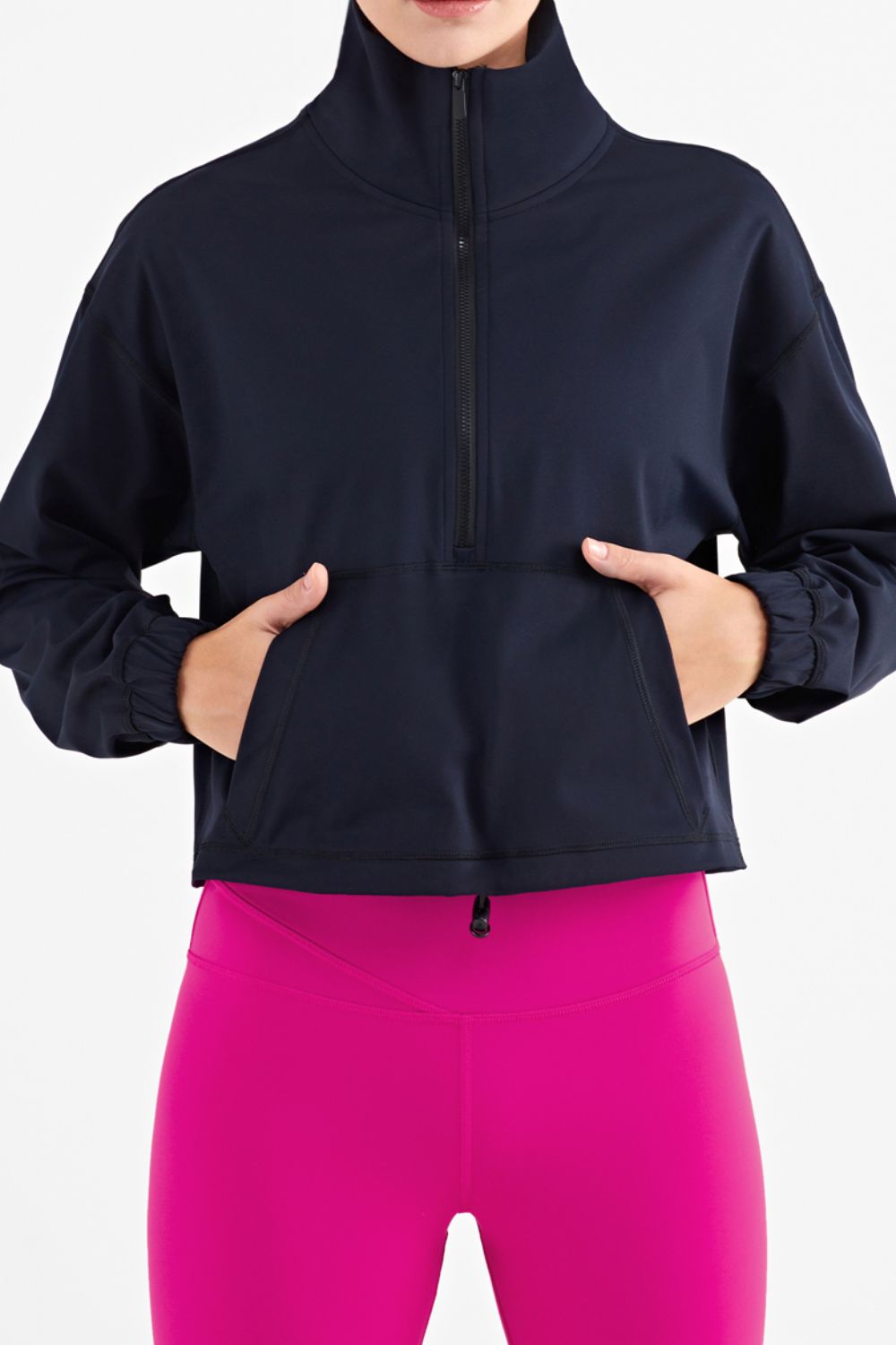 Half-Zip Dropped Shoulder Sports Top in a studio setting, showcasing its high neck and long sleeves, made from stretchy nylon and spandex.