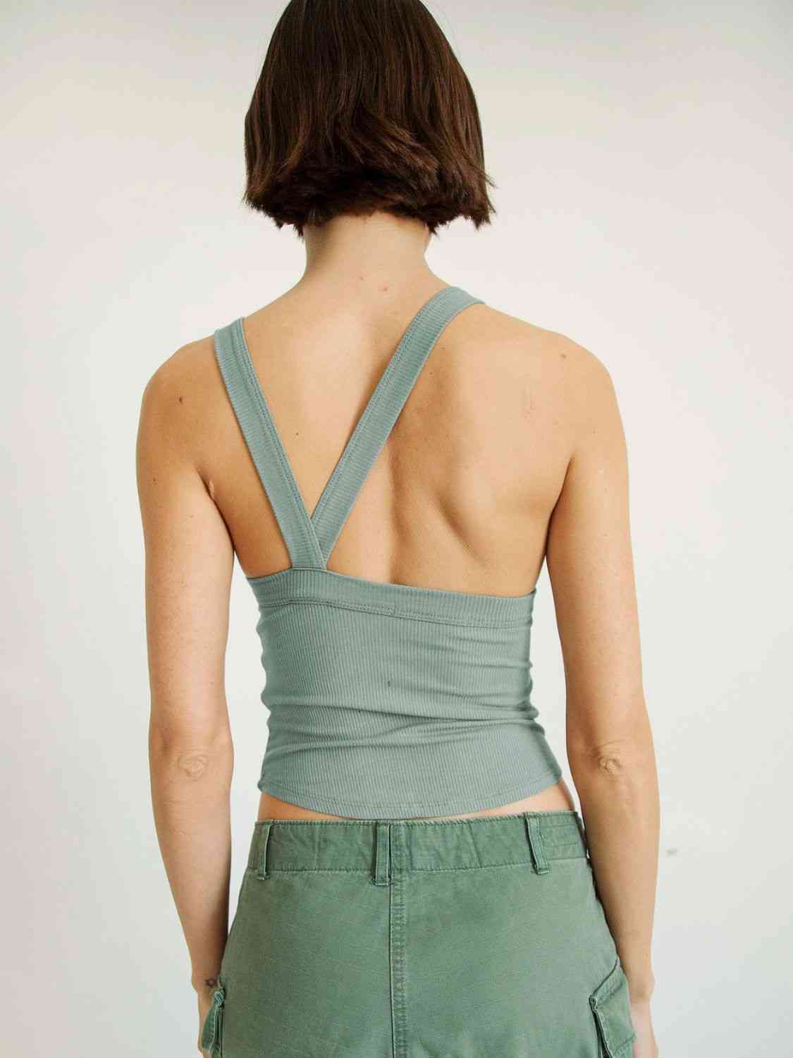 A stylish Halter Neck Ribbed Cropped Top in solid color, showcasing its backless design and sleeveless style, perfect for casual summer wear.