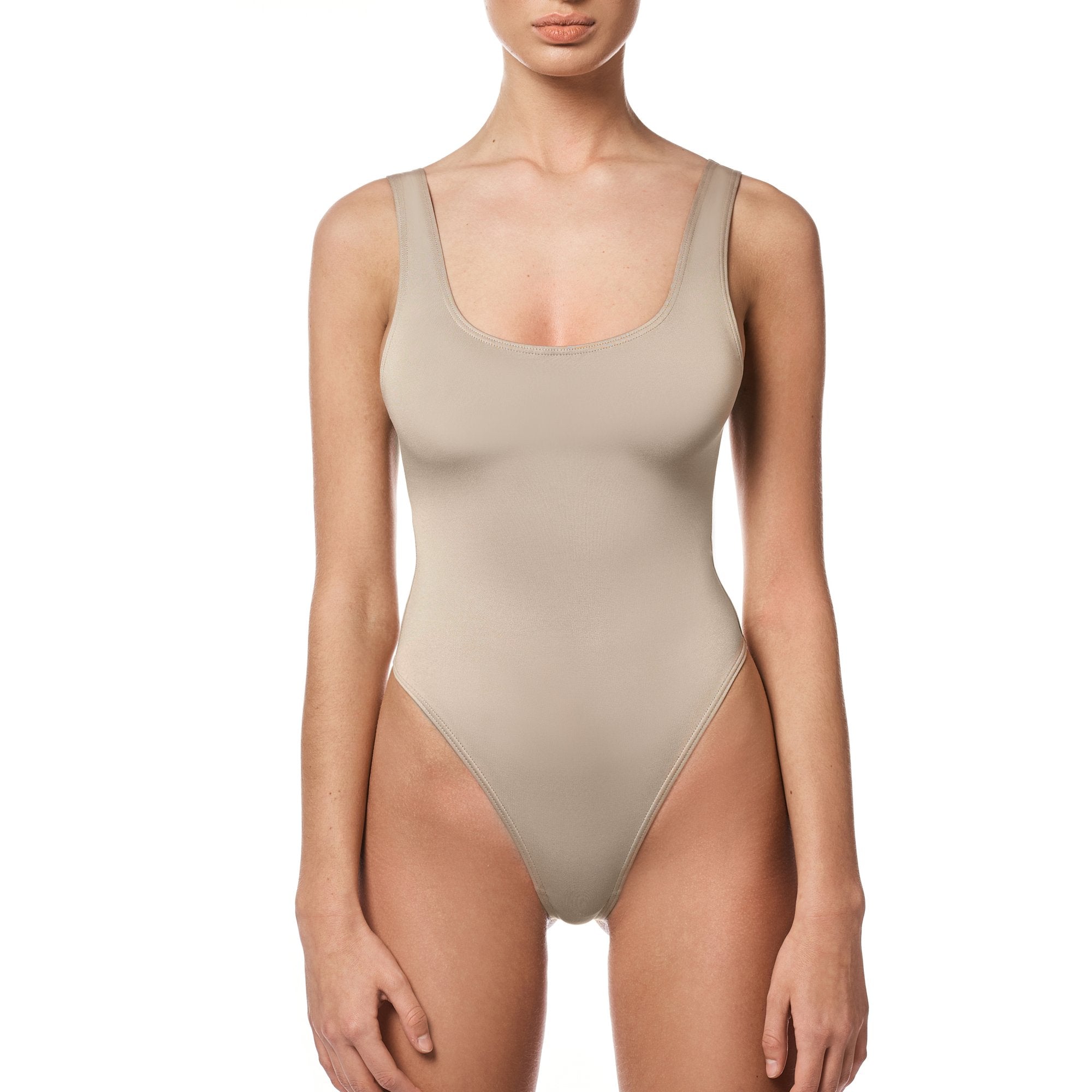 A stylish nude bodysuit designed for versatility and comfort, featuring a flattering fit and snap closure.