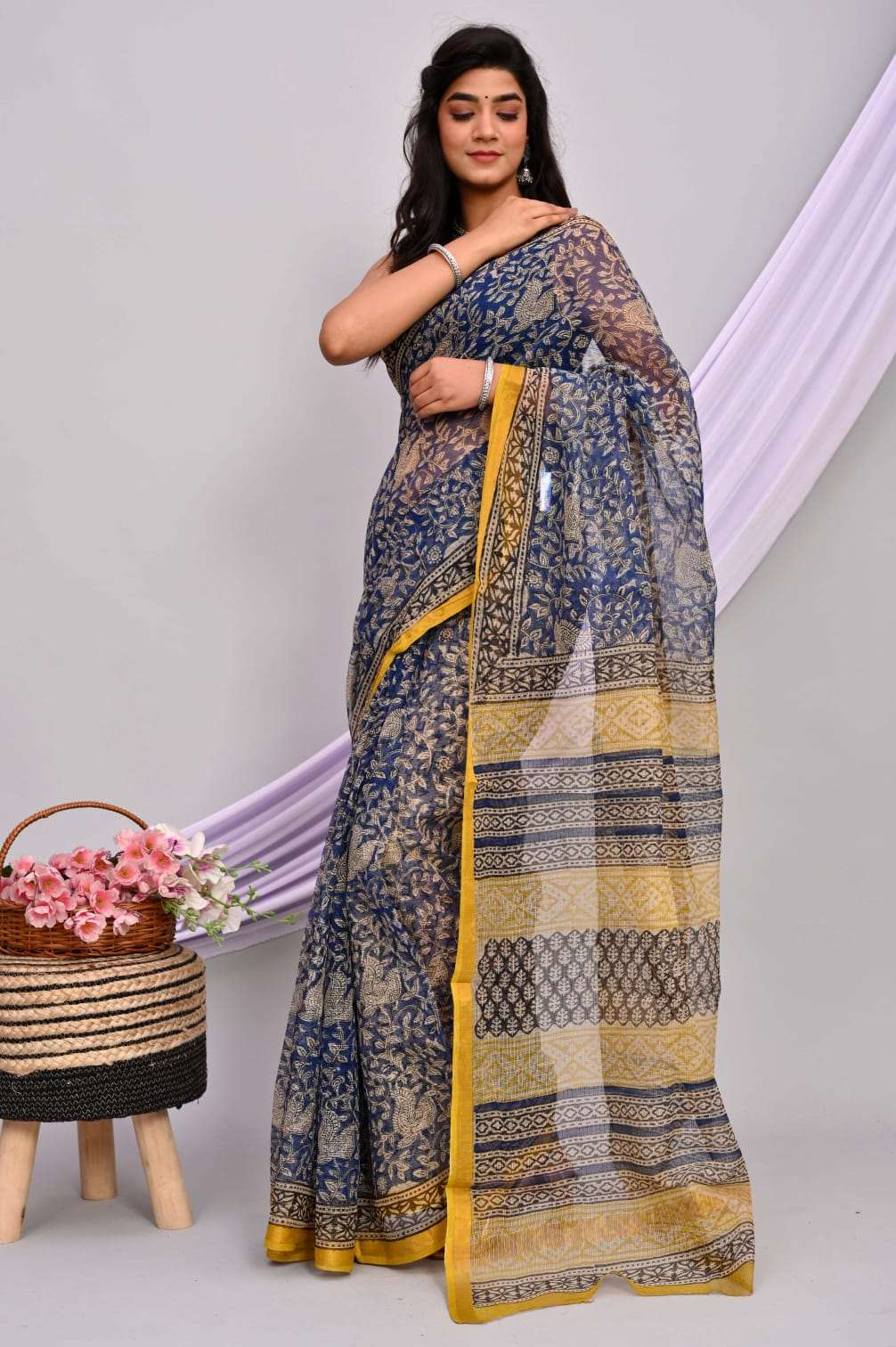 A beautifully draped hand block printed Kota Doria saree showcasing intricate patterns and vibrant colors, perfect for elegant occasions.