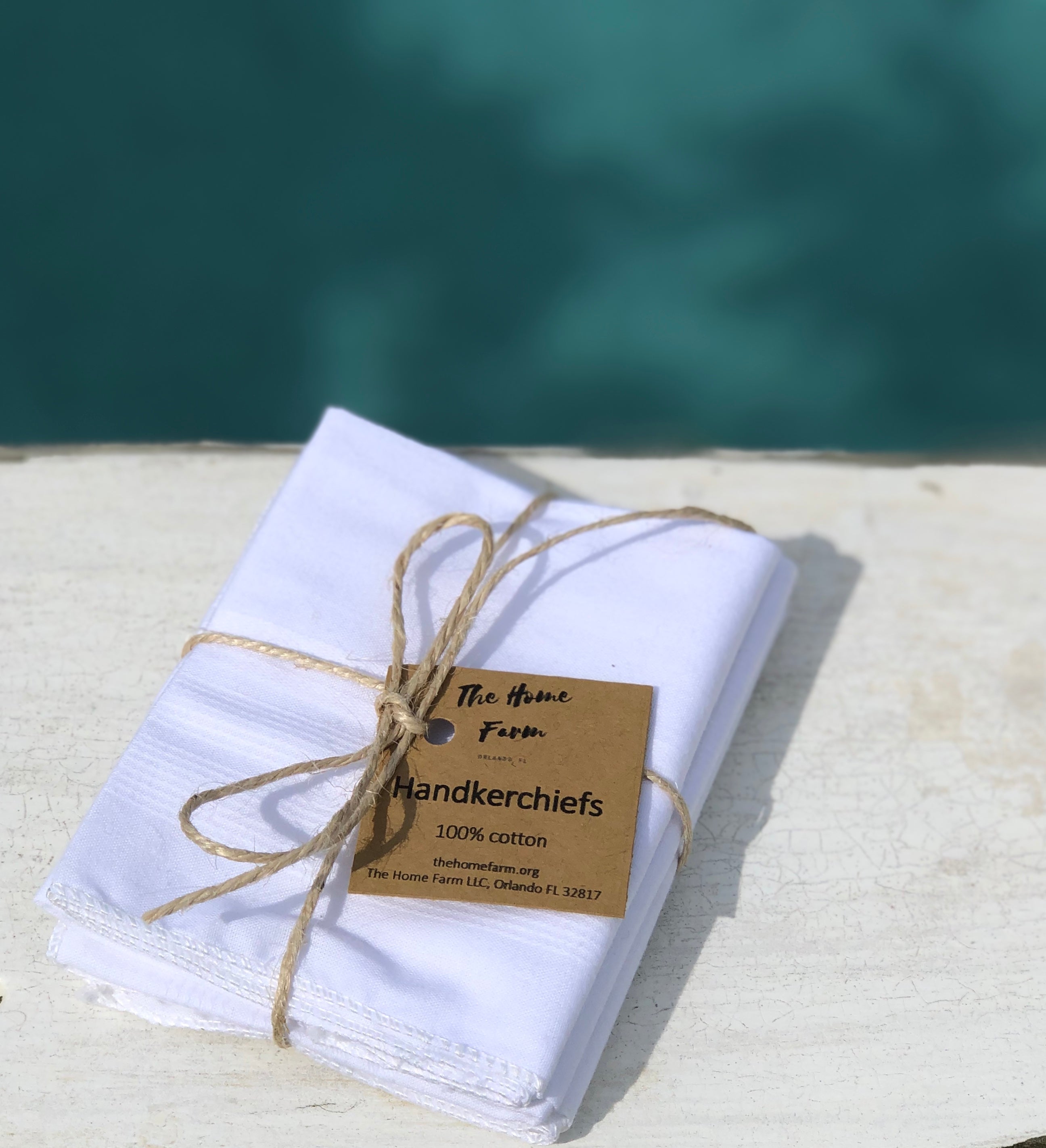 A set of three elegant handkerchiefs made from 100% cotton, showcasing their soft texture and eco-friendly design, perfect for stylish use.