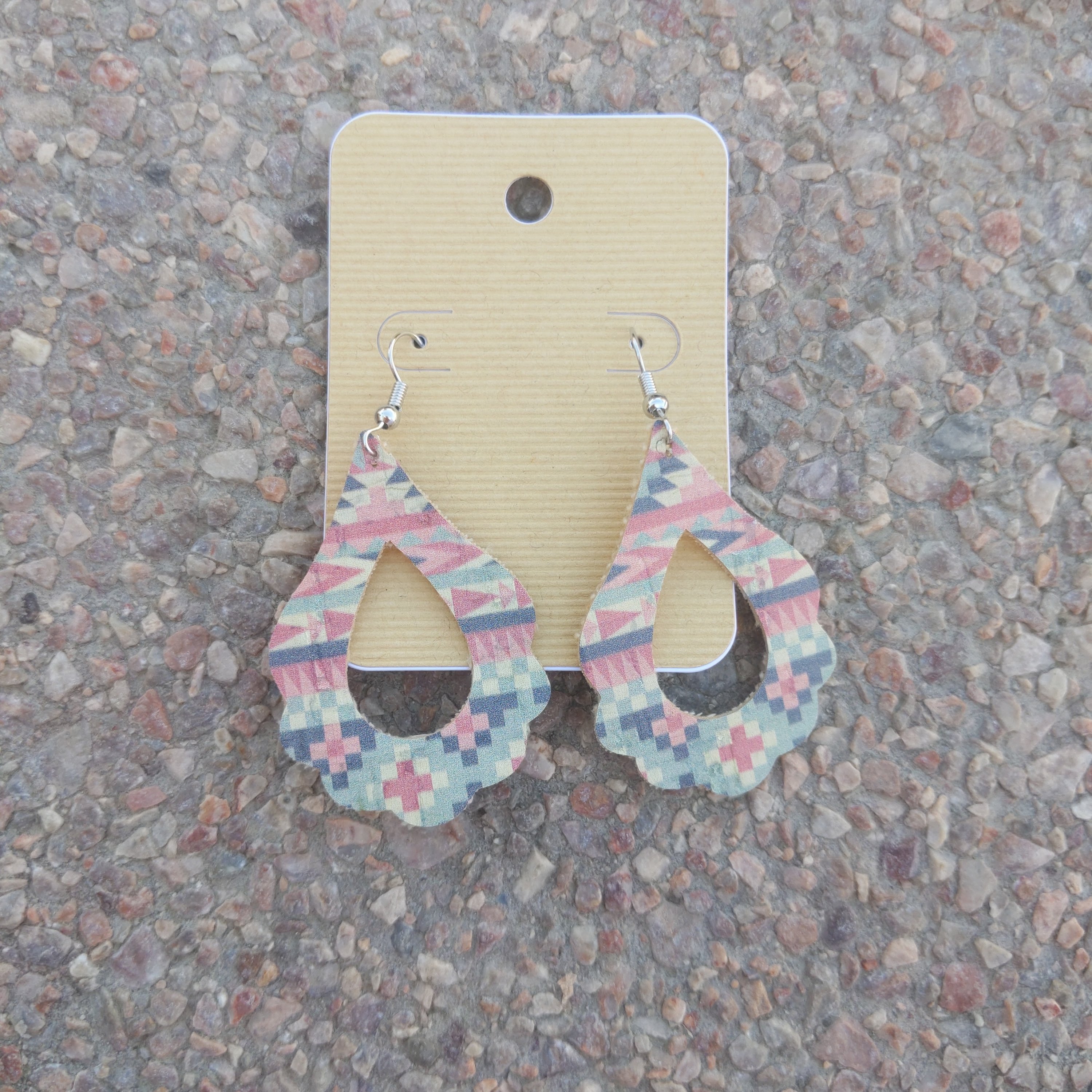 A pair of trendy handmade Aztec cork earrings, showcasing intricate patterns and lightweight design, perfect for any outfit.