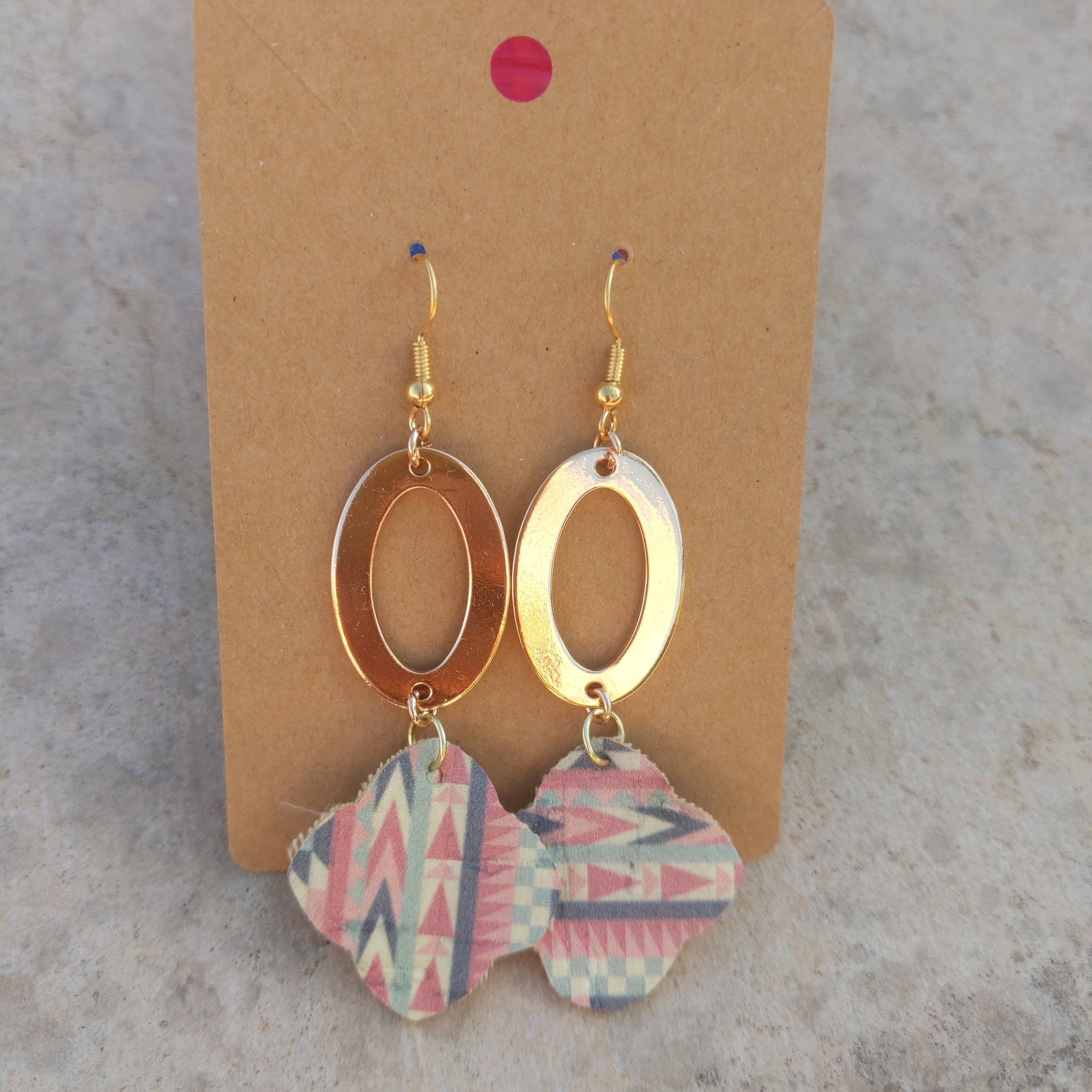 A pair of unique Handmade Aztec dangle earrings featuring intricate designs with gold disks and cork elements, showcasing their lightweight and stylish appeal.