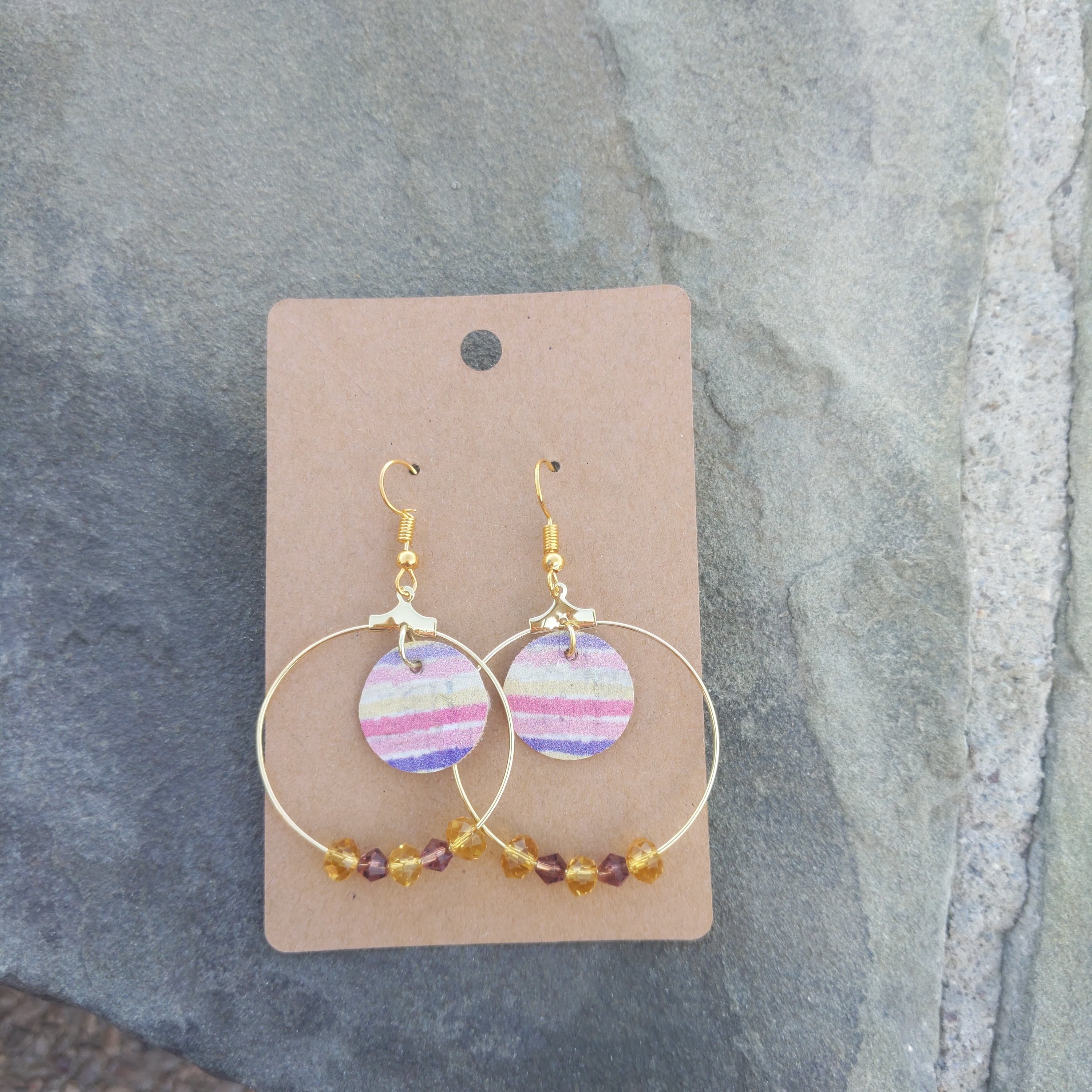 Handmade hoopel cork earrings featuring colorful shades of yellow, purple, and pink with sparkling crystal bead accents.