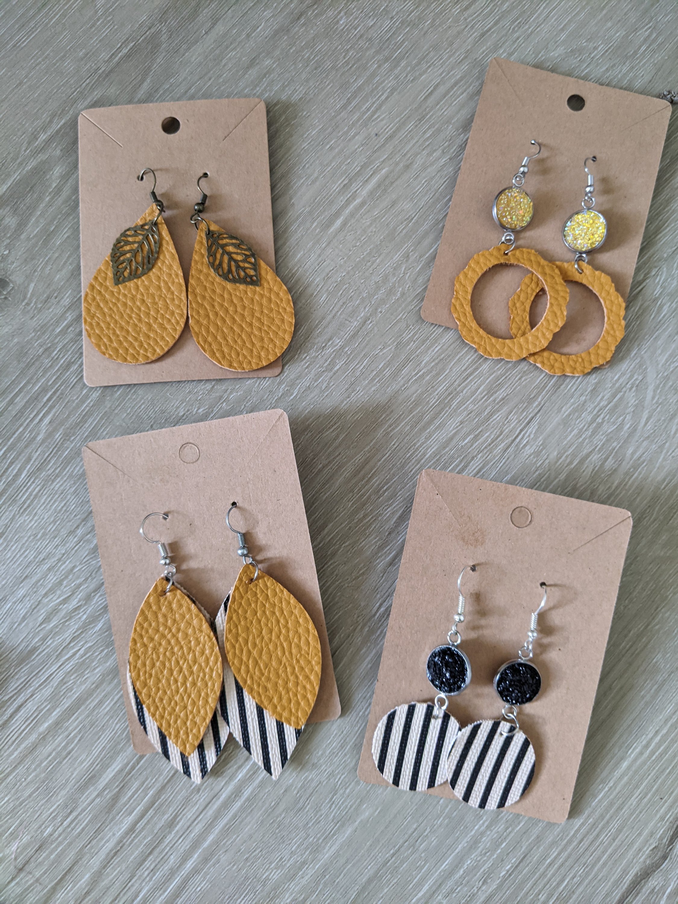 Handmade mustard and black striped faux leather earrings, lightweight and uniquely designed, perfect for any occasion.