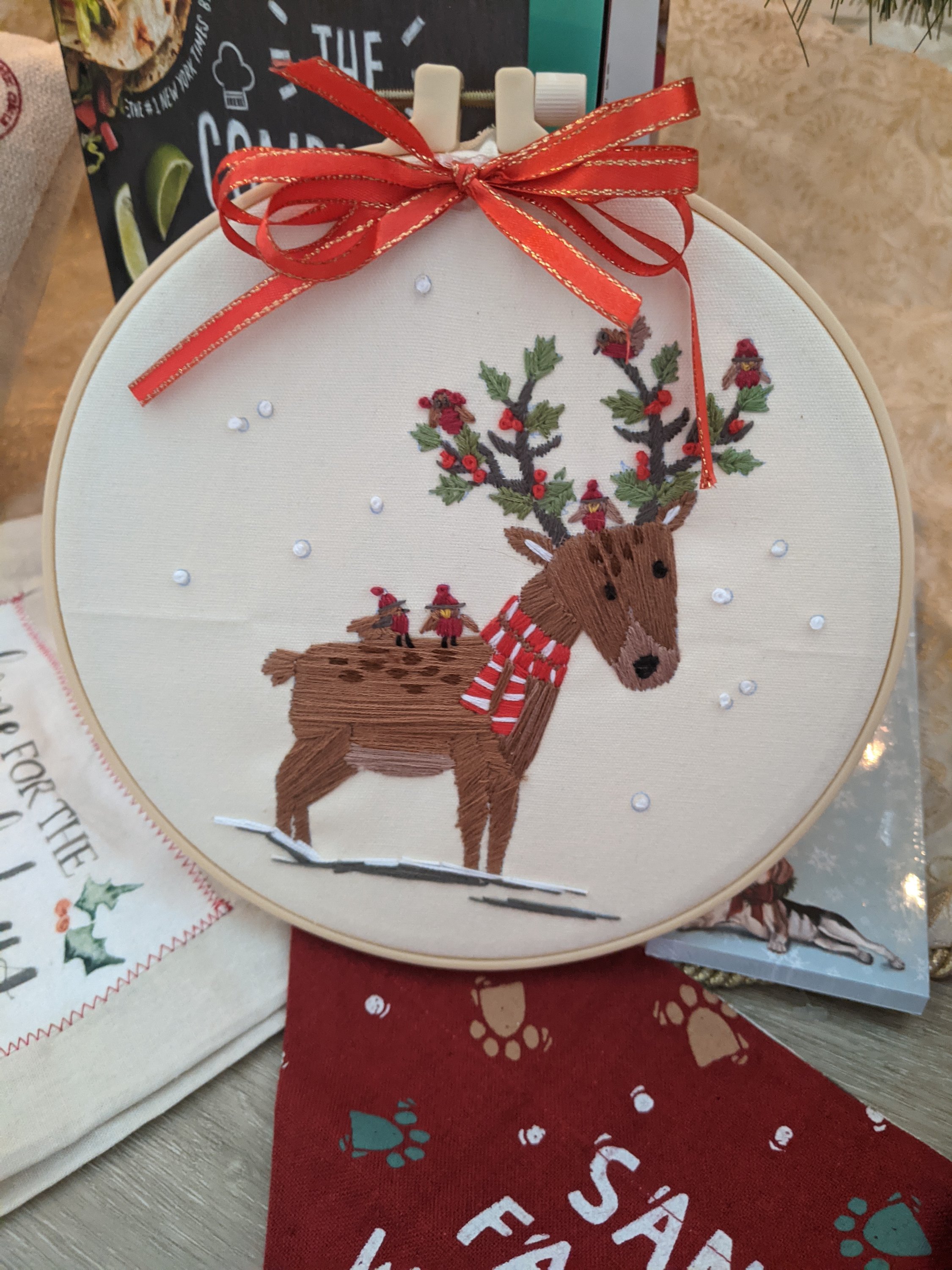 Handmade reindeer embroidered hoop wall decor featuring intricate stitching and vibrant colors, perfect for home decoration.