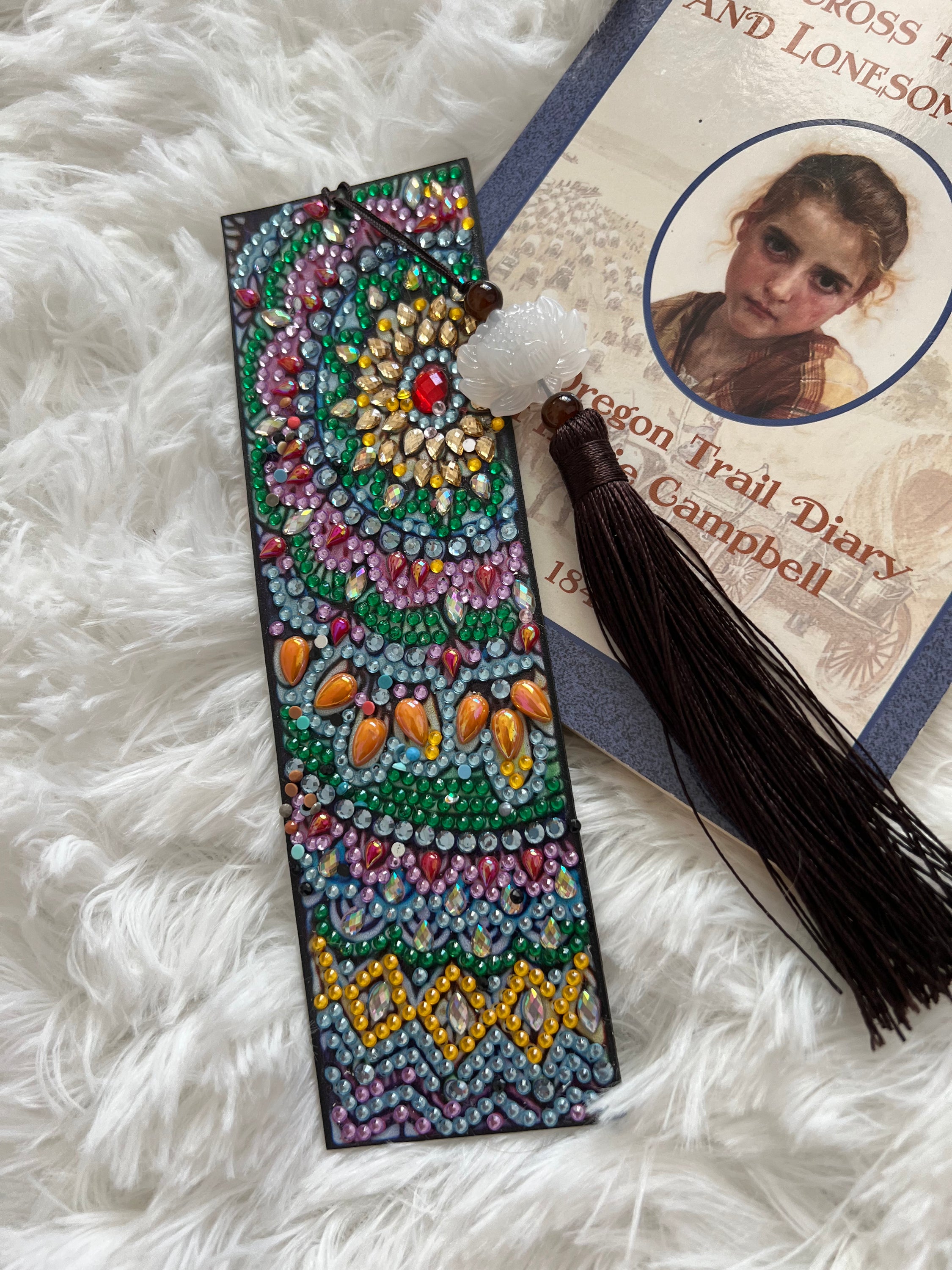 A beautifully crafted handmade rhinestone bookmark featuring sparkling rhinestones on a sturdy base, perfect for book lovers.