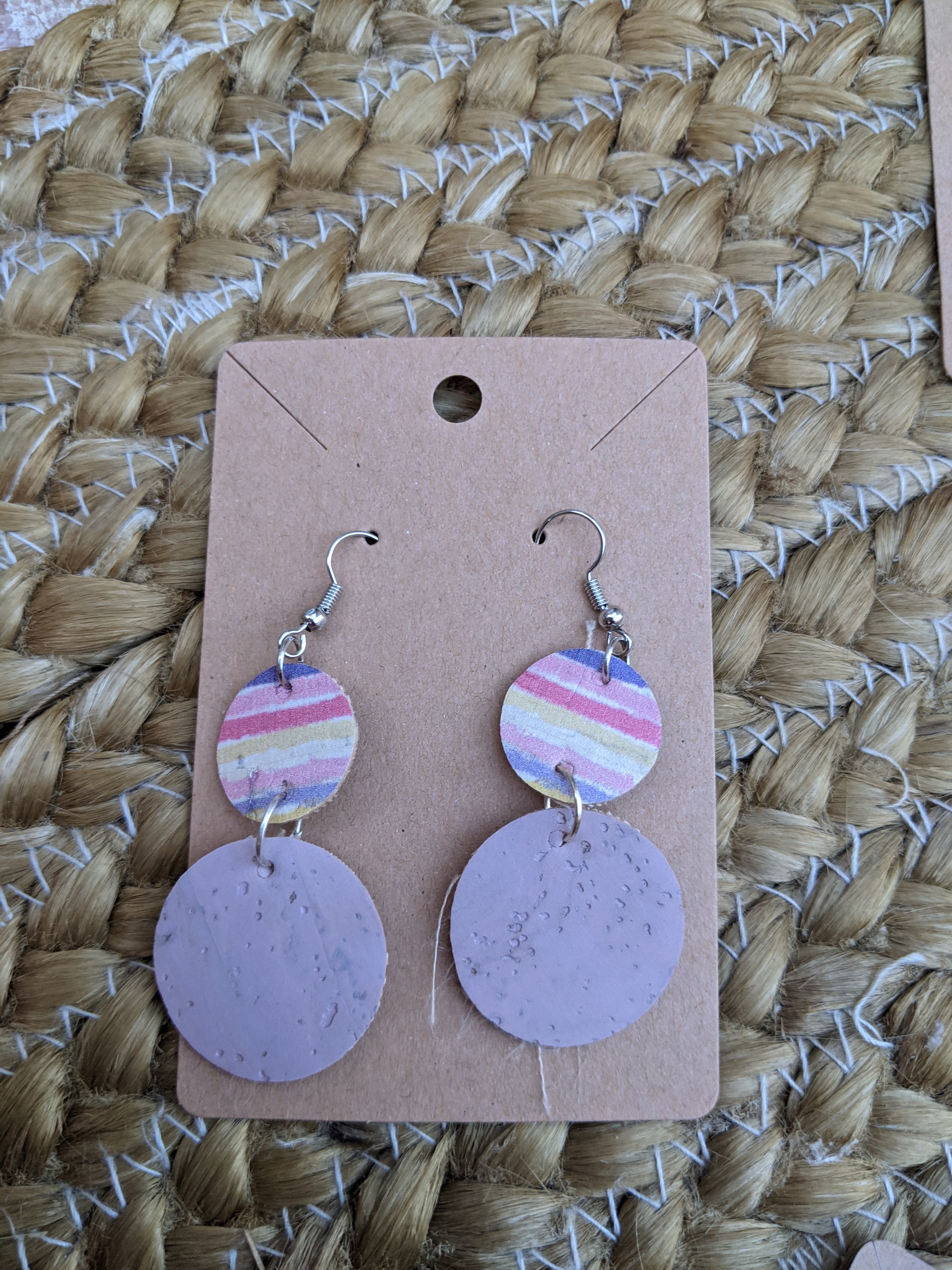 Handmade round cork rainbow earrings featuring vibrant colors and a silver filigree leaf accent, lightweight and stylish.