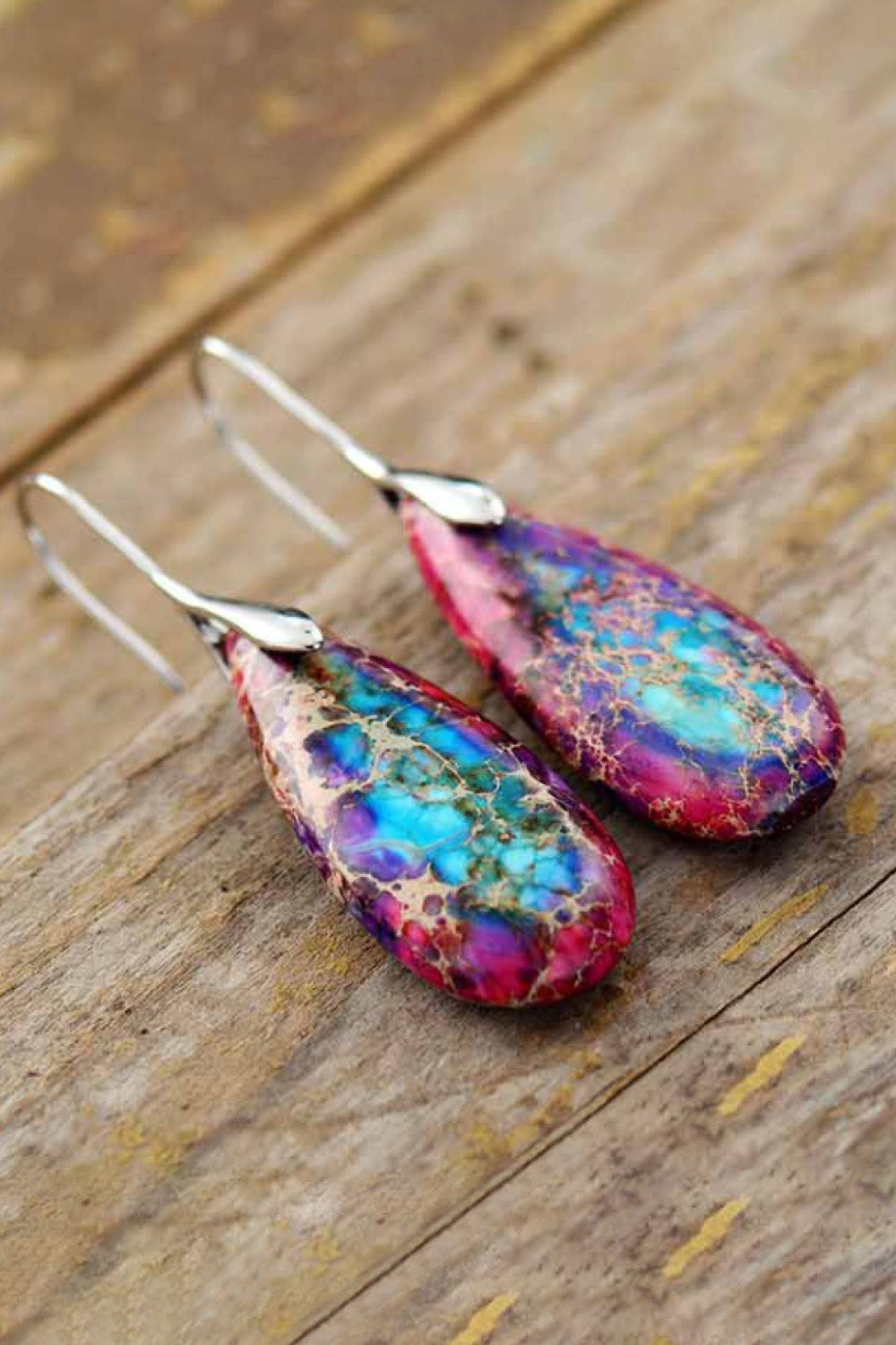 Handmade teardrop shape dangle earrings featuring natural stones, copper, and gold plating, showcasing unique patterns and modern design.