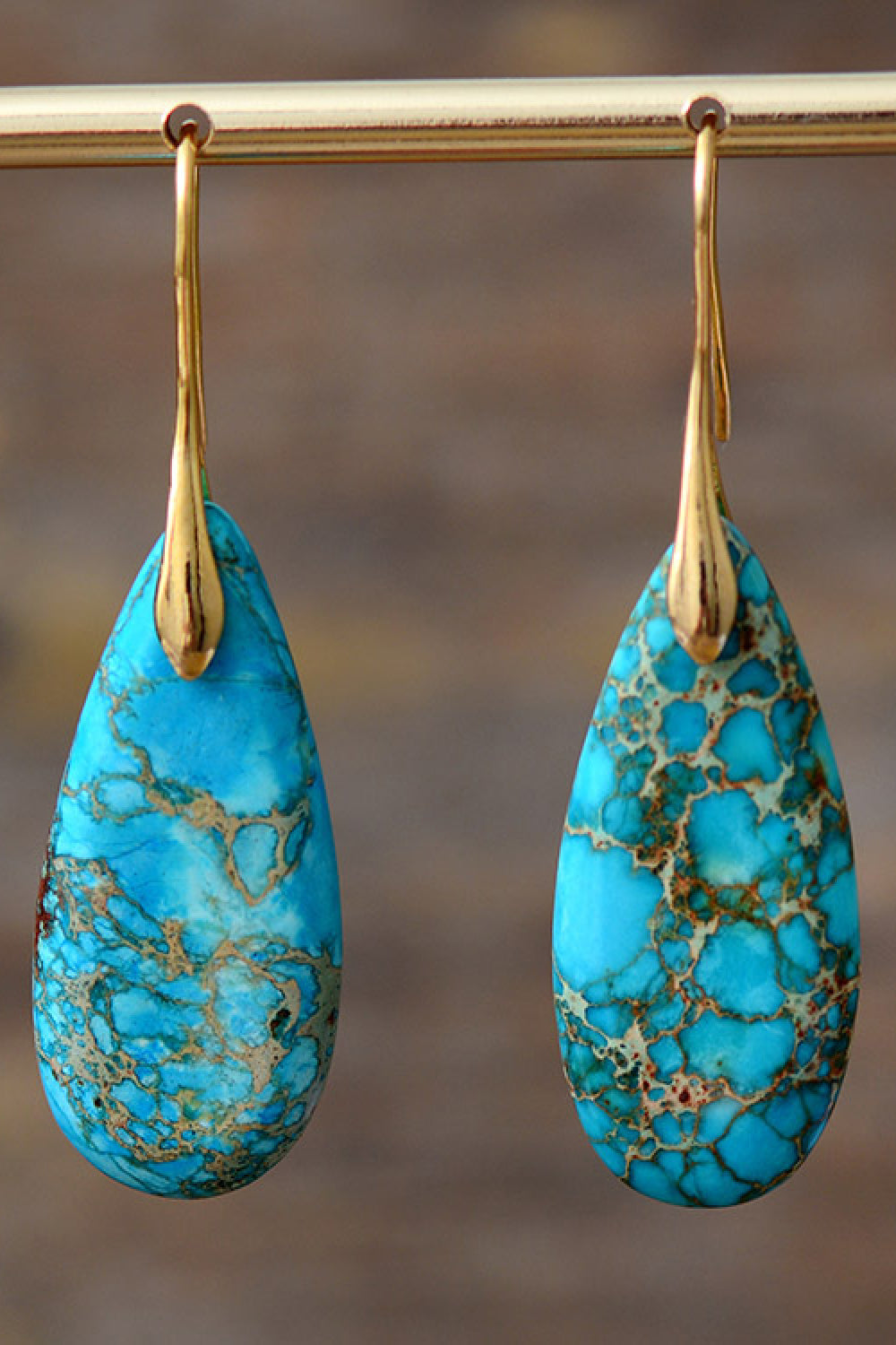 Handmade teardrop shape dangle earrings featuring natural stones, copper, and gold plating, showcasing unique patterns and modern design.