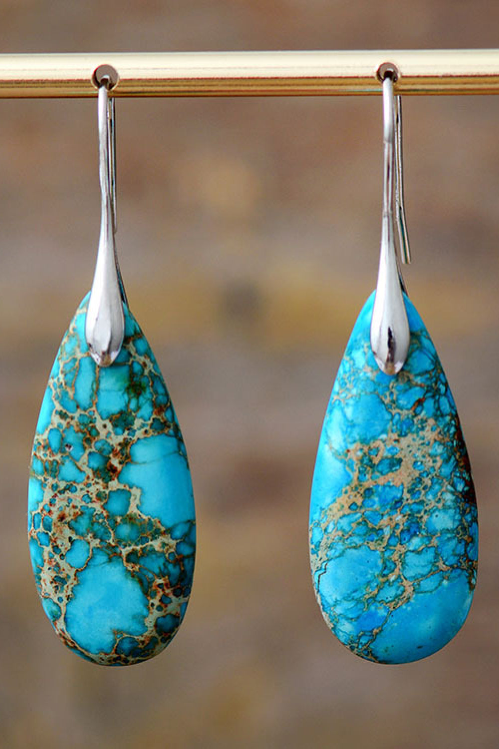 Handmade teardrop shape dangle earrings featuring natural stones, copper, and gold plating, showcasing unique patterns and modern design.